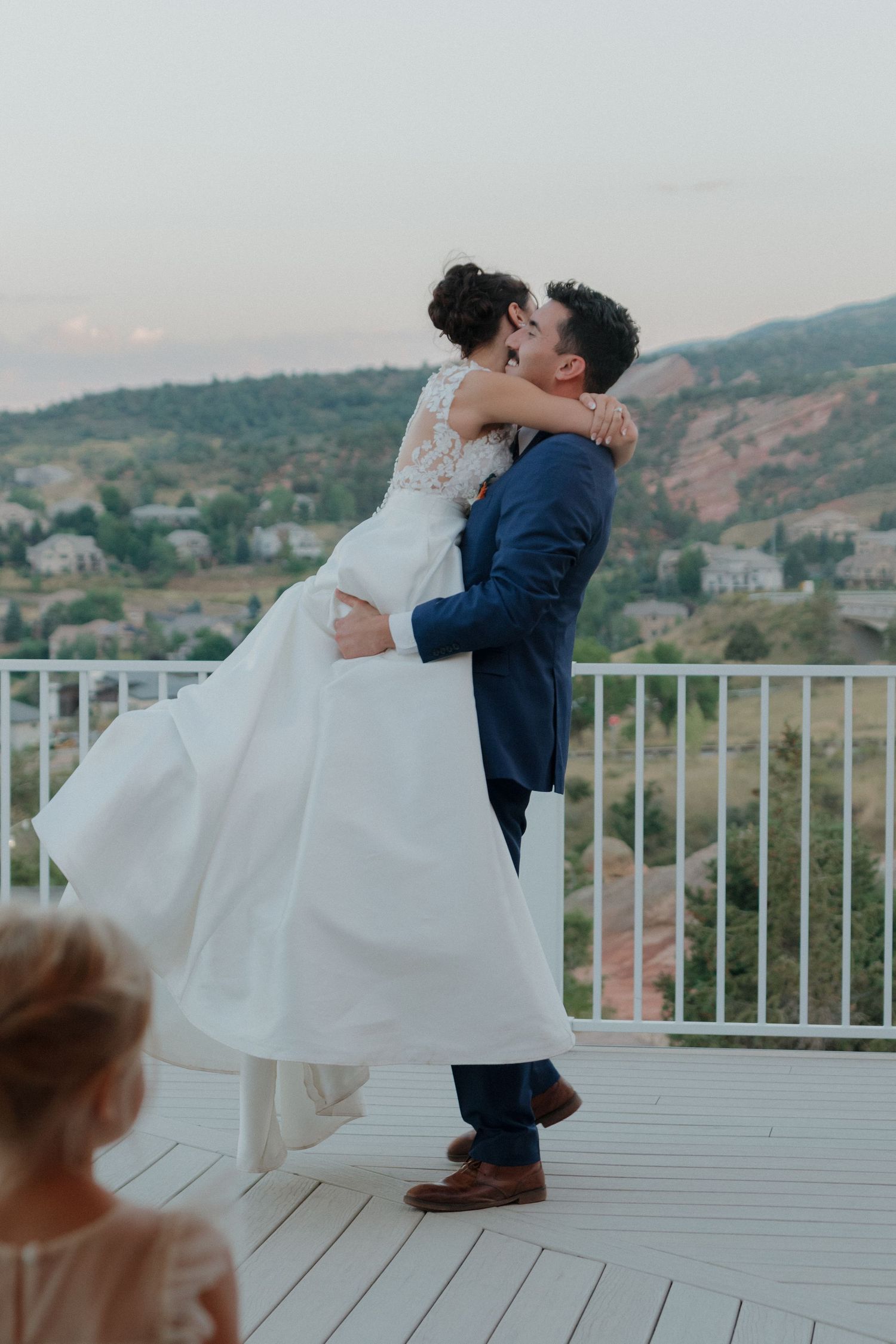 Romantic dance dip on an outdoor deck with mountain views in the background.