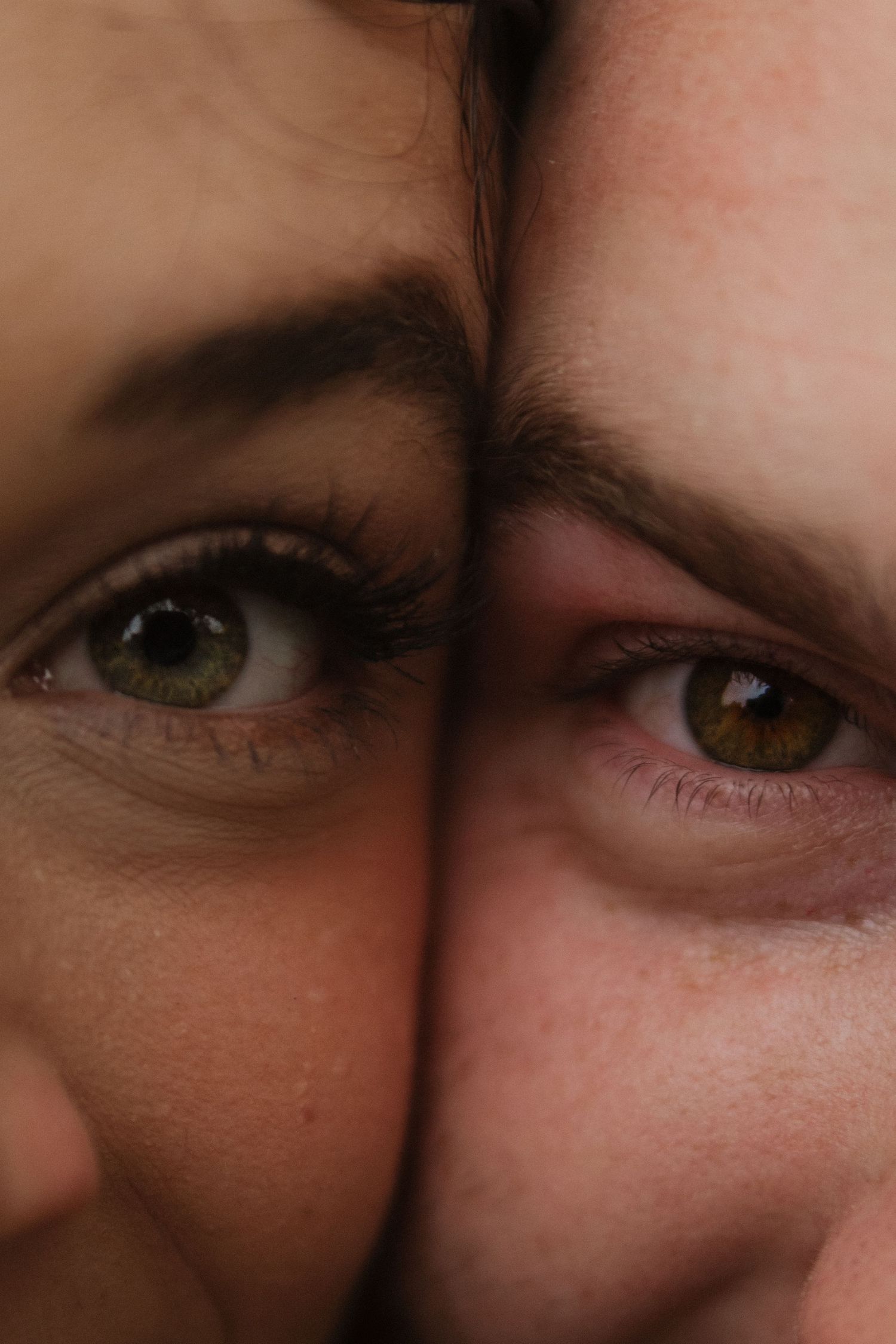 Extreme close-up of two sets of eyes looking at each other with affection.