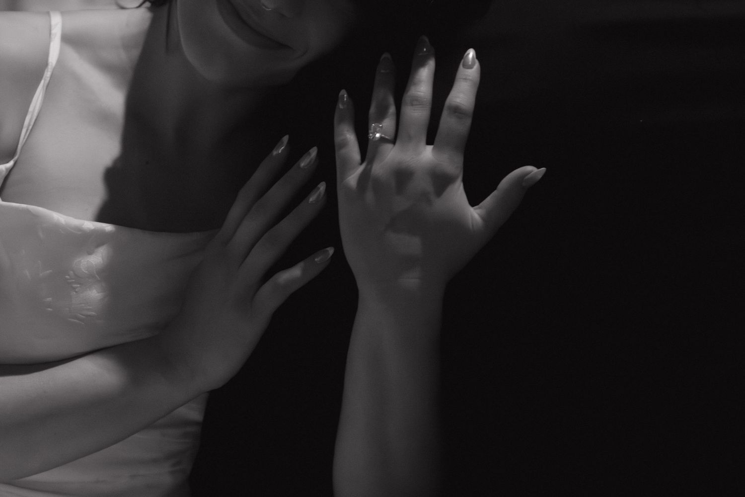 Black and white artistic portrait showing dramatic shadows and gestures.