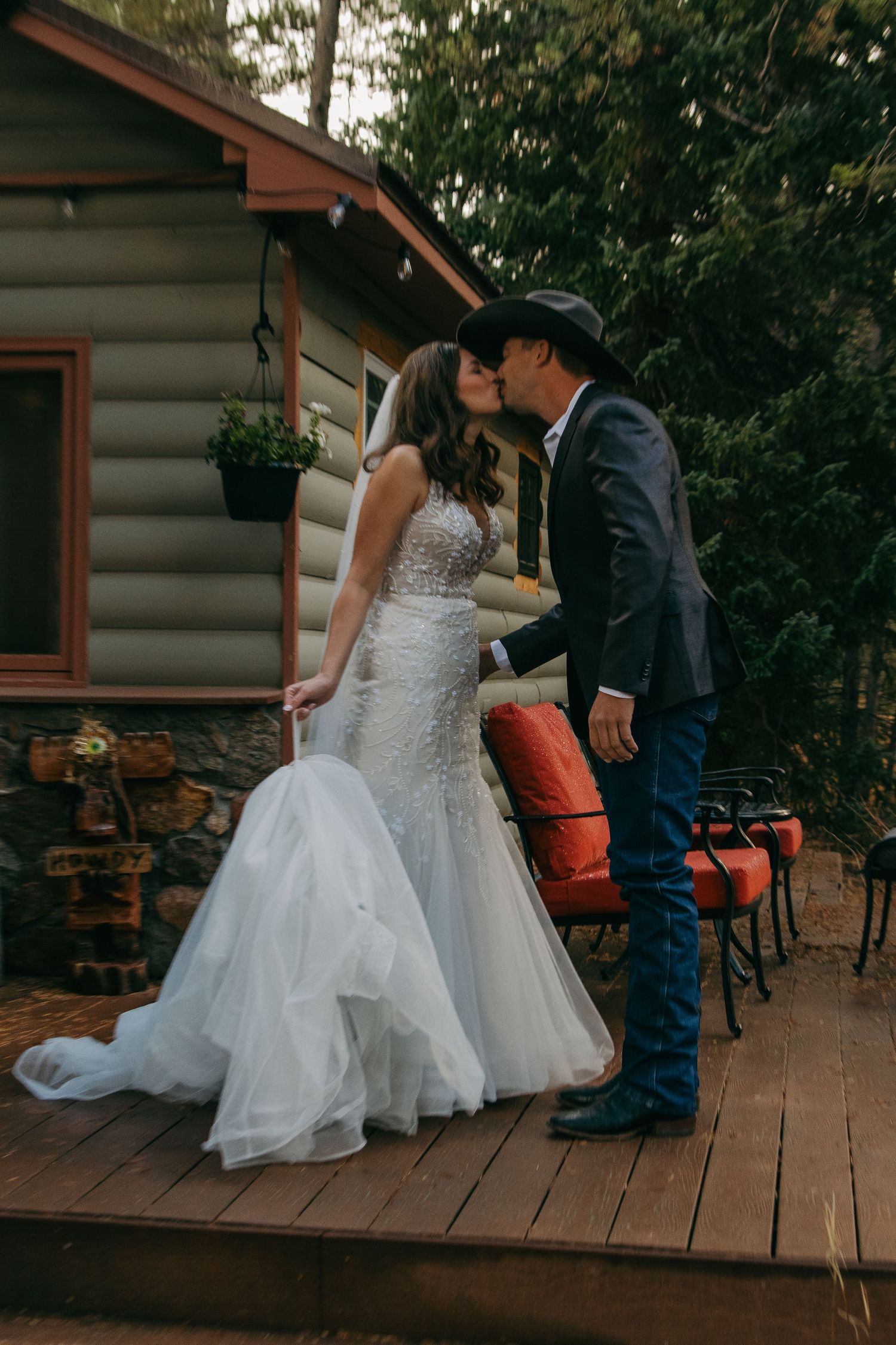 A couple on a rustic wooden deck during their wedding ceremony.