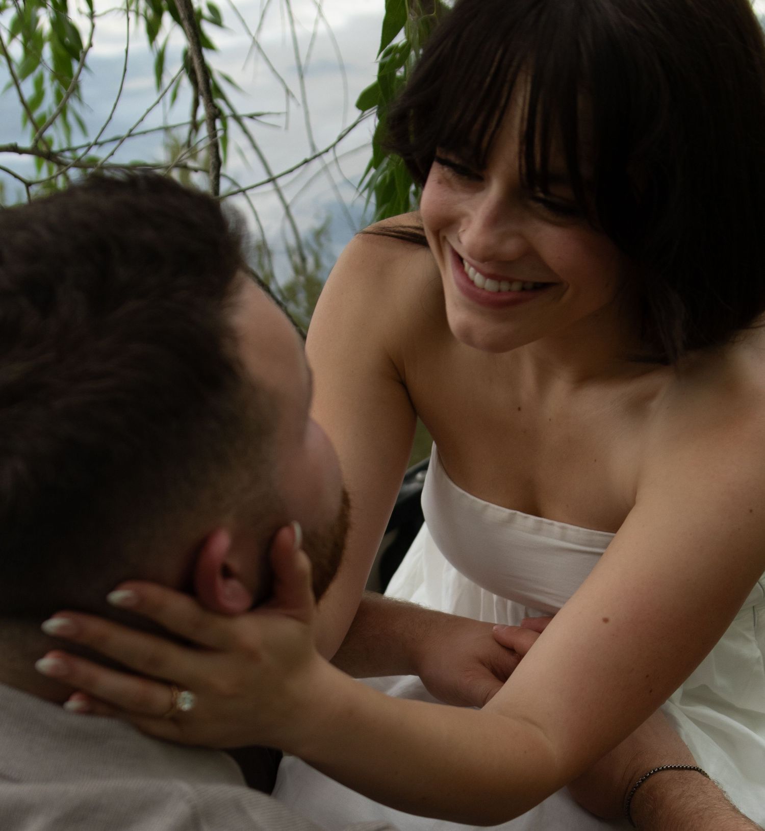 Intimate couple sharing a tender embrace in soft natural lighting.