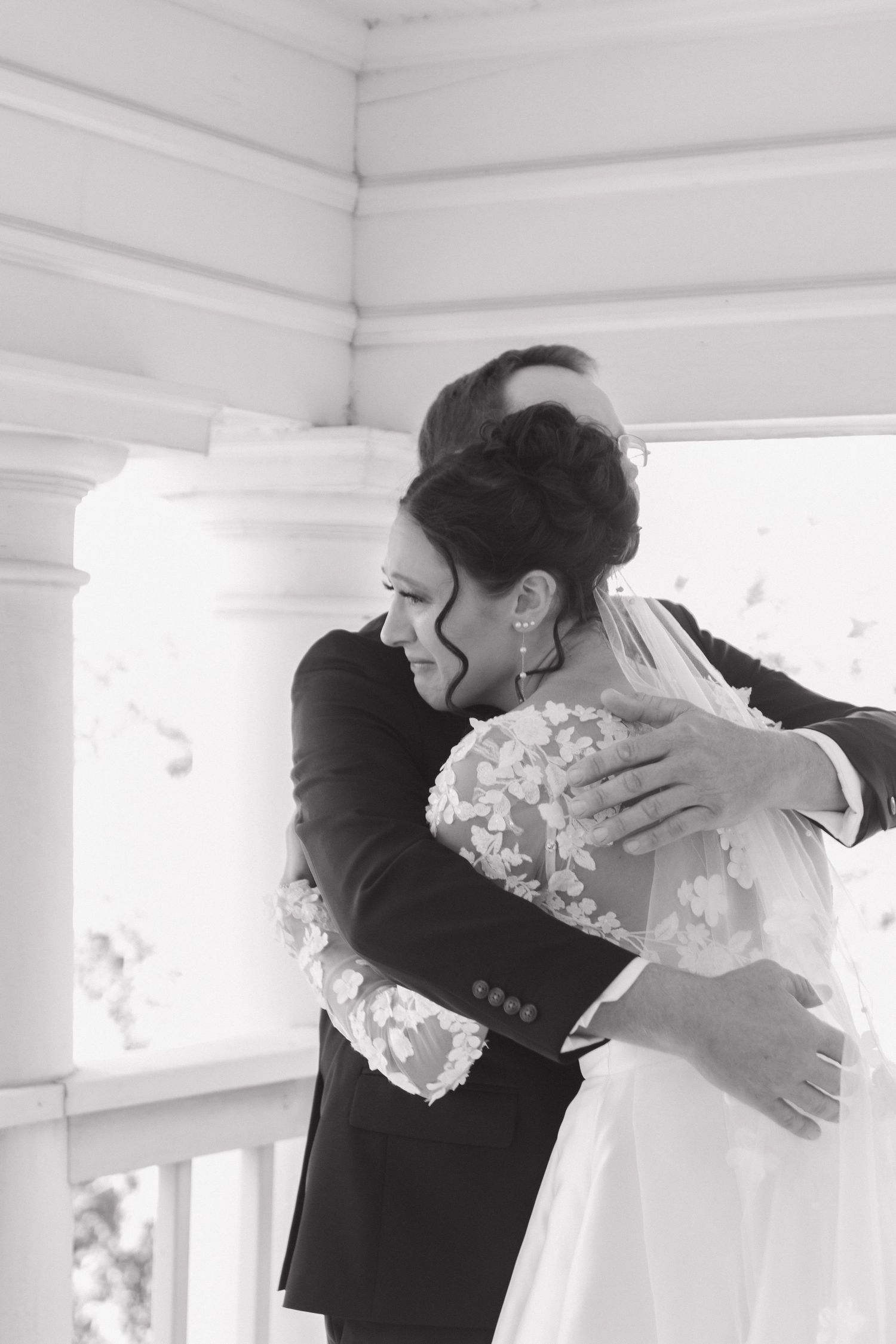 Black and white photos capturing emotional first look moments on a sunlit porch.