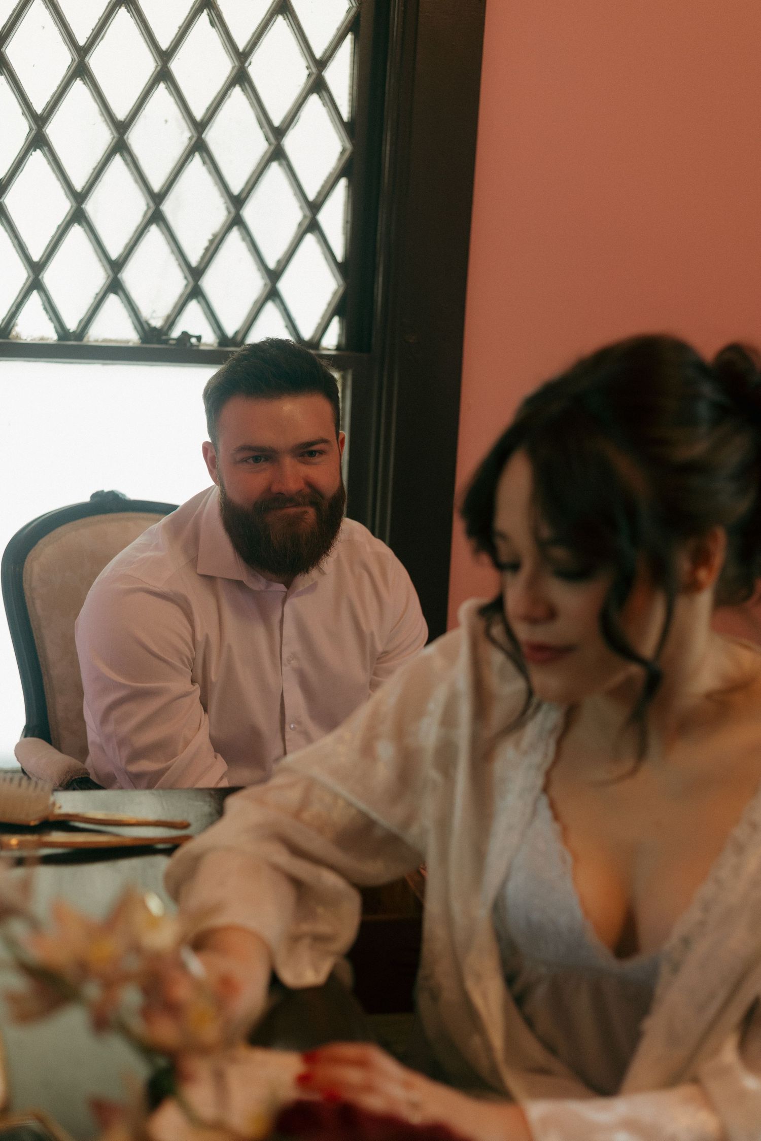 A couple sits together at a table during their wedding celebration.