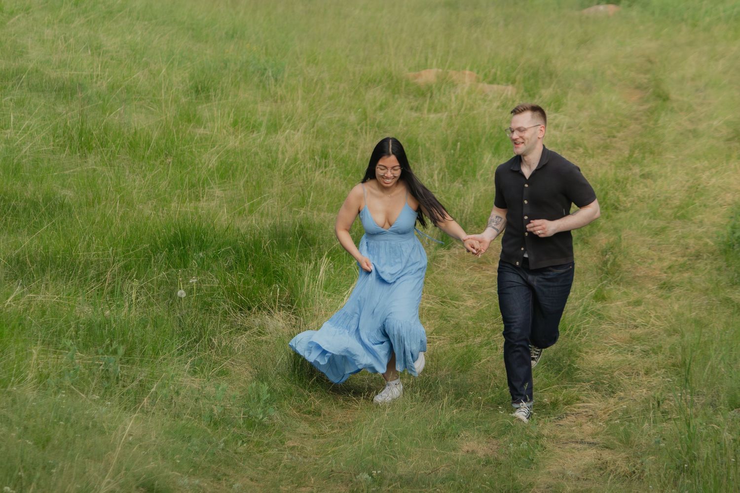 Candid moments captured during a casual outdoor photoshoot on green grass.