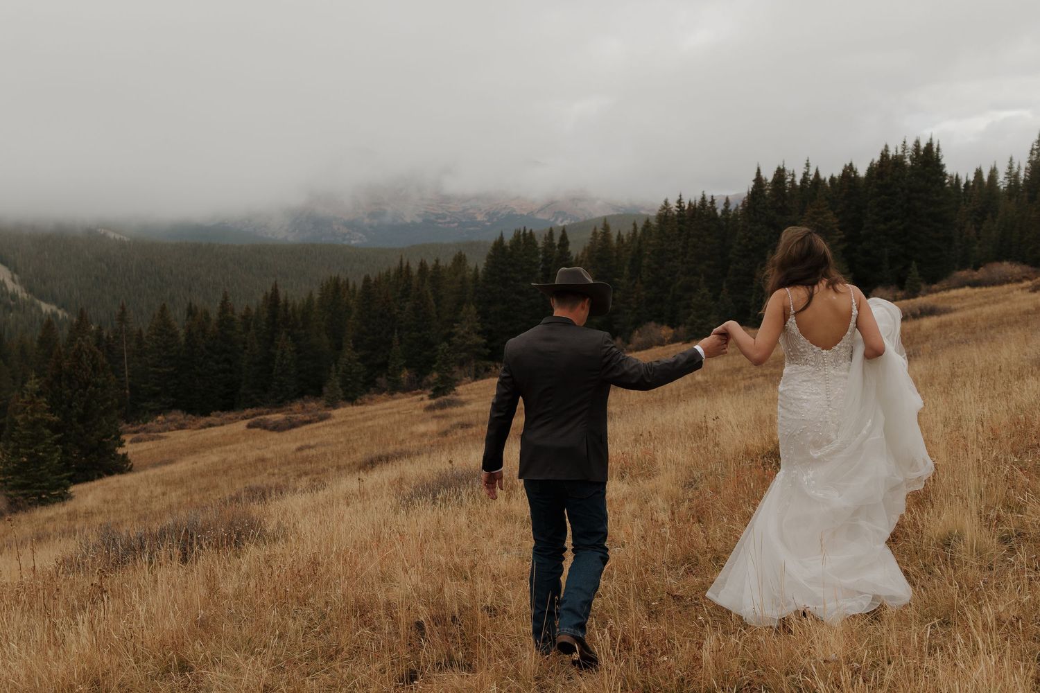 Dancing in a mountain meadow with dramatic mountain landscape.