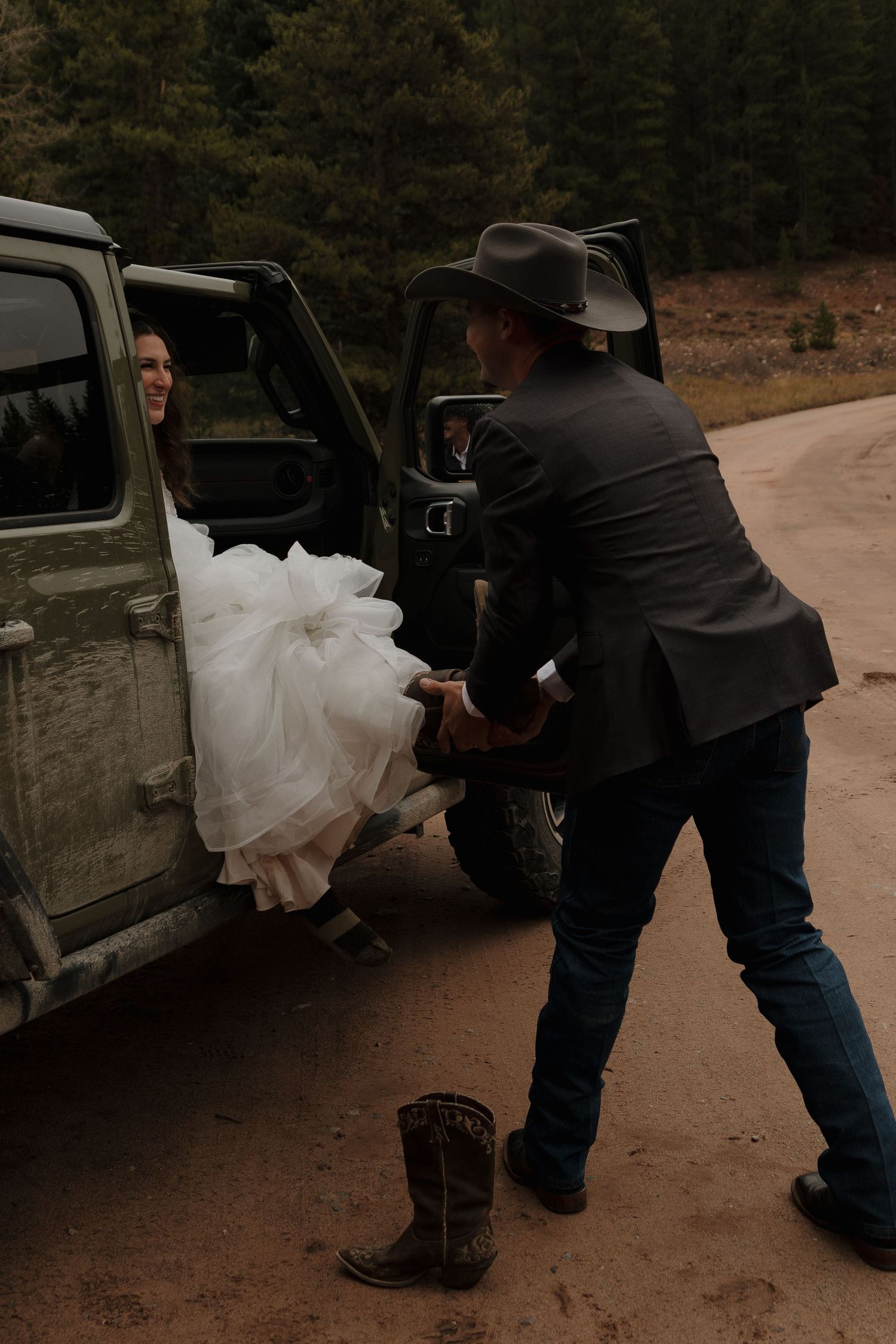 Wedding couple getting into a vintage vehicle on their special day.