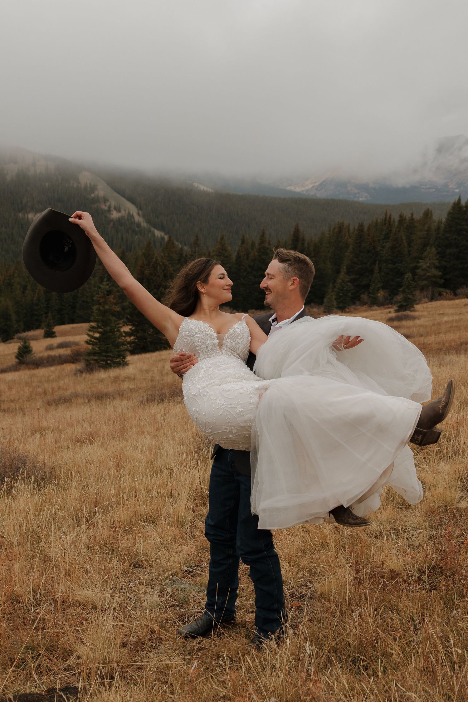 A joyful dancing sequence in a mountain meadow with dramatic cloudy skies.