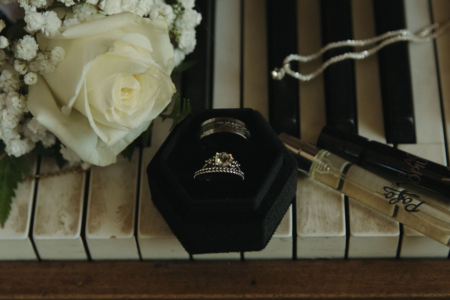 White roses and piano keys create an elegant composition in black and white.