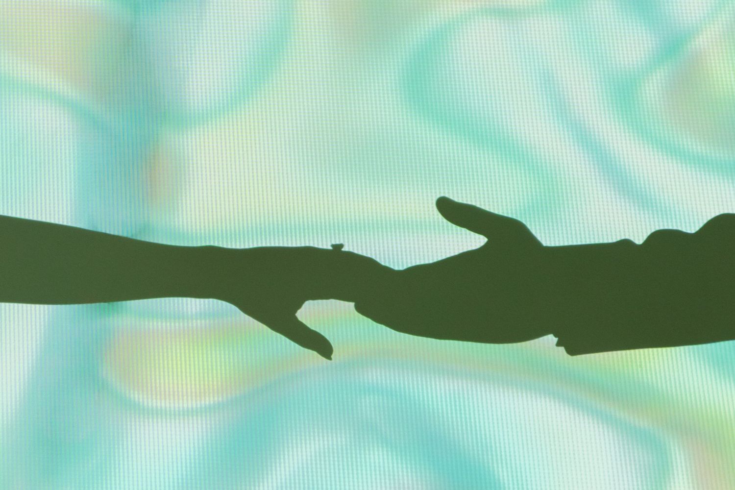 Abstract blue-green background with dark silhouettes creating a flowing wave pattern.