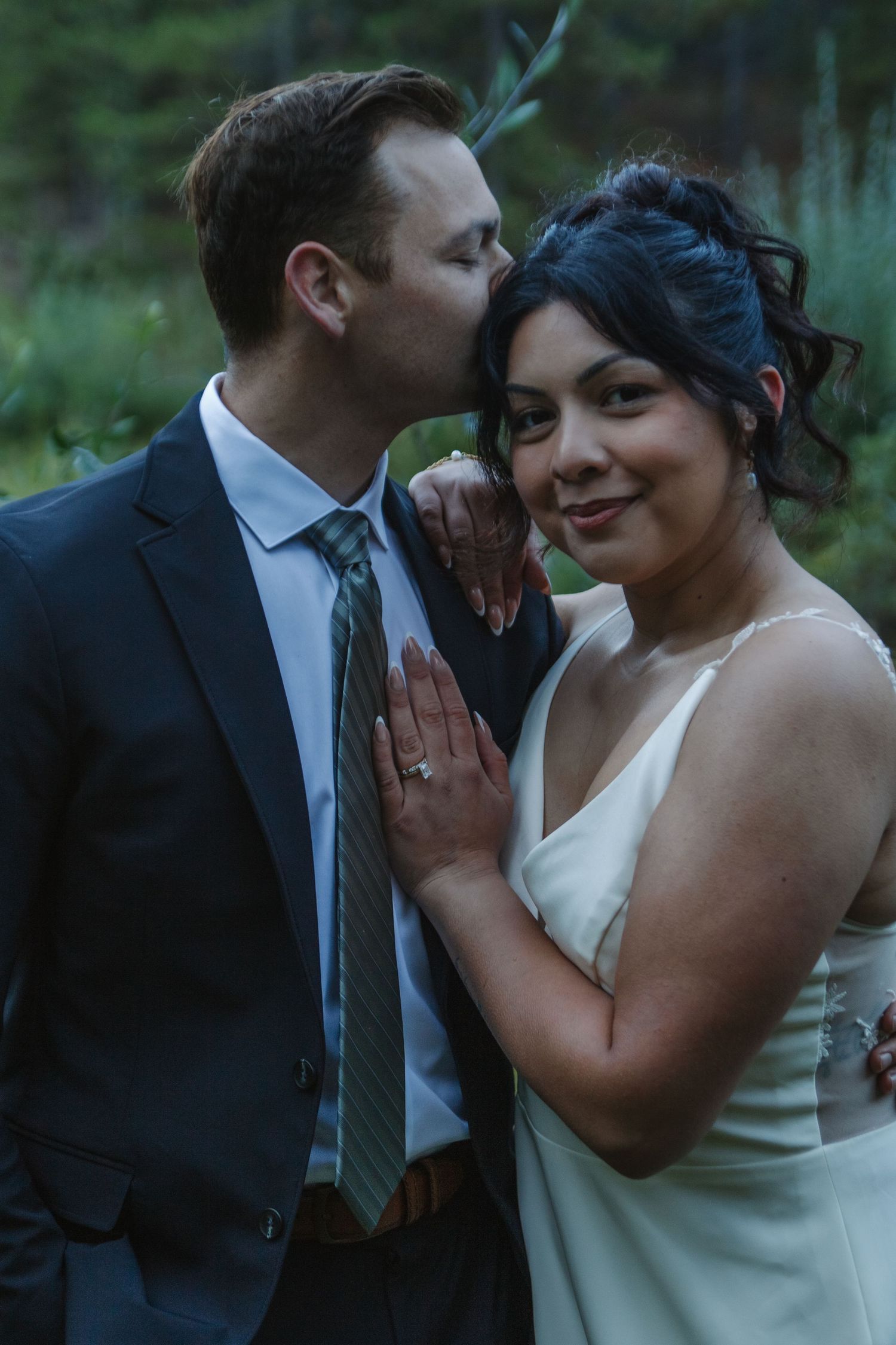 Romantic wedding moment captured during an intimate mountain ceremony.