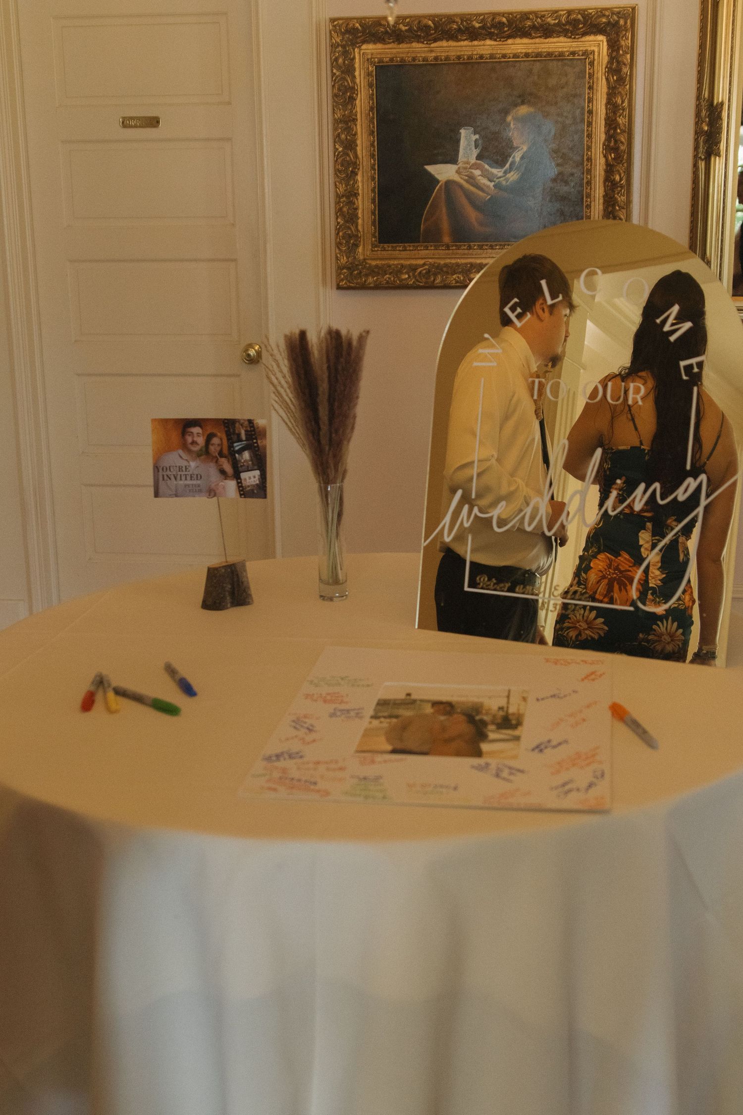 Wedding guest book and decor displayed on elegant table at reception venue.