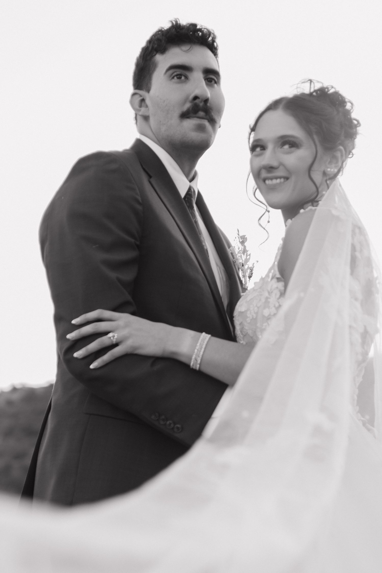 Black and white romantic wedding portraits showing tender moments between newlyweds.