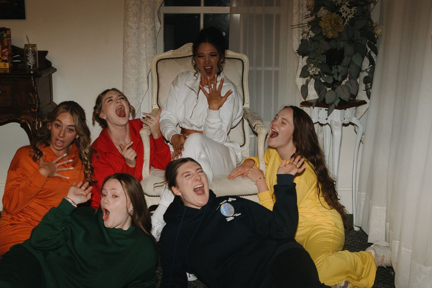 Wedding party members making animated expressions during fun photo session.