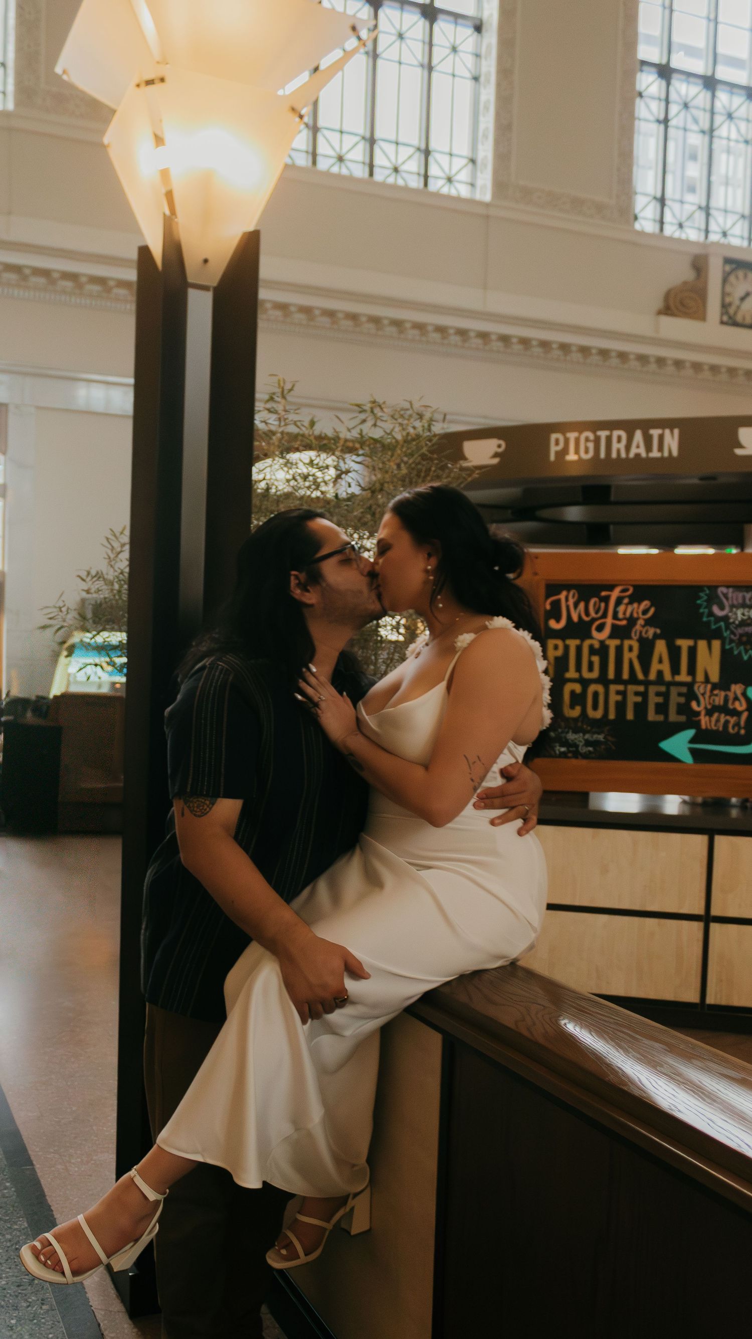 A couple dancing romantically in front of a vintage cafe counter.
