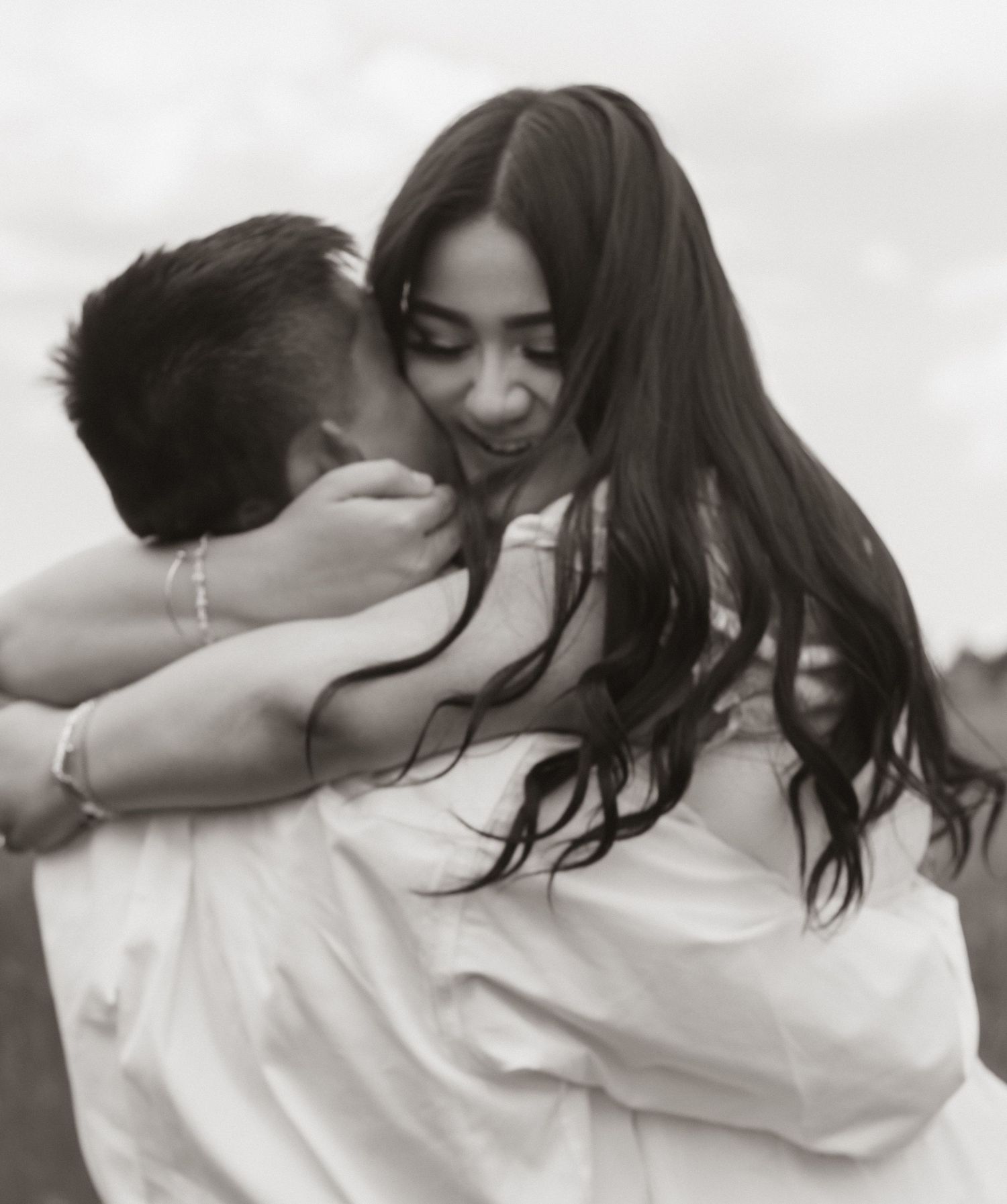 A romantic black and white photo sequence showing a tender embrace in candid moments.