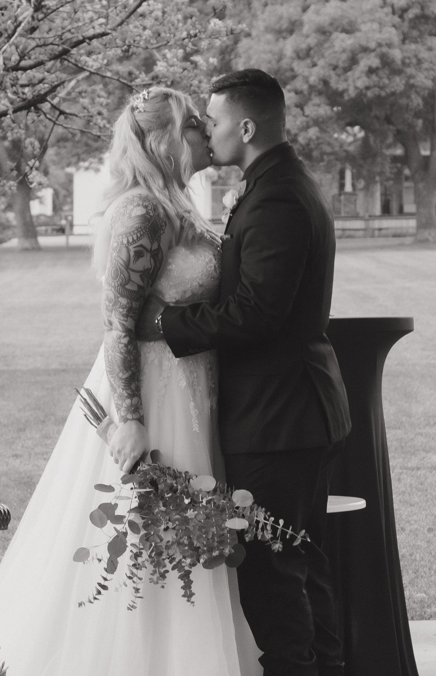 A romantic black and white wedding photoshoot sequence showing intimate moments between a couple in formal attire.