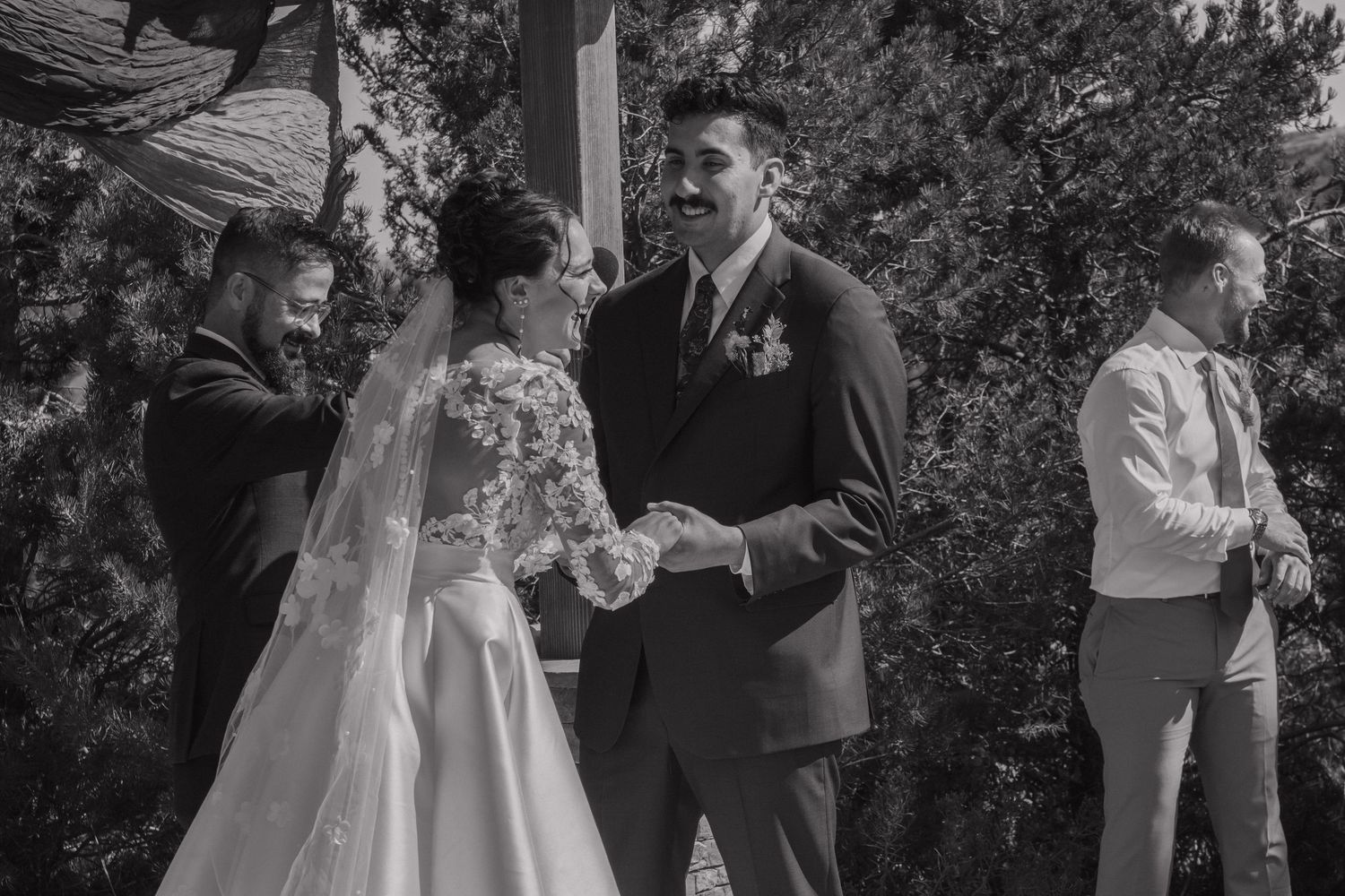 Black and white series showing emotional moments during outdoor wedding ceremony.