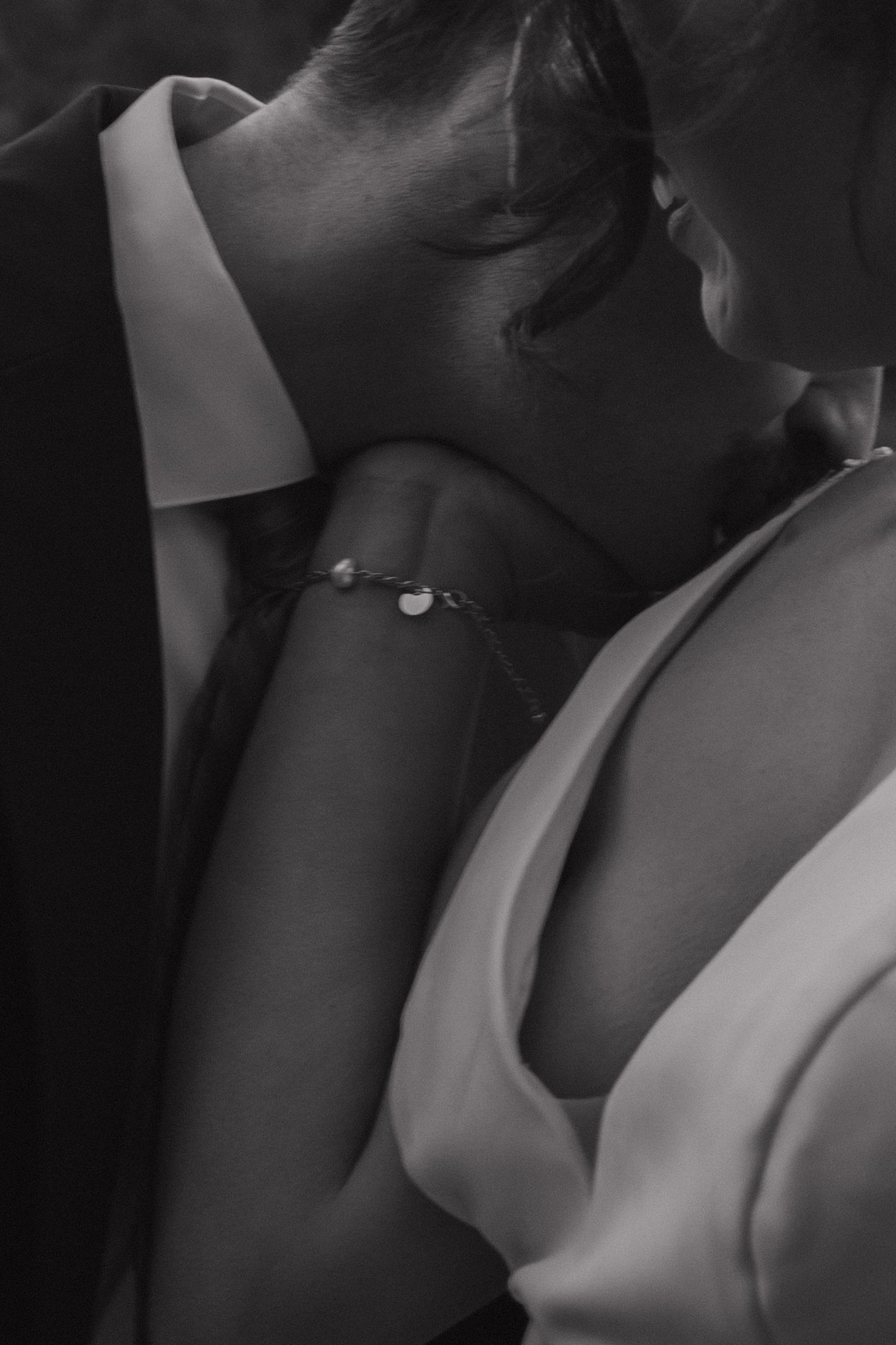 An intimate black and white portrait capturing tender wedding moments.