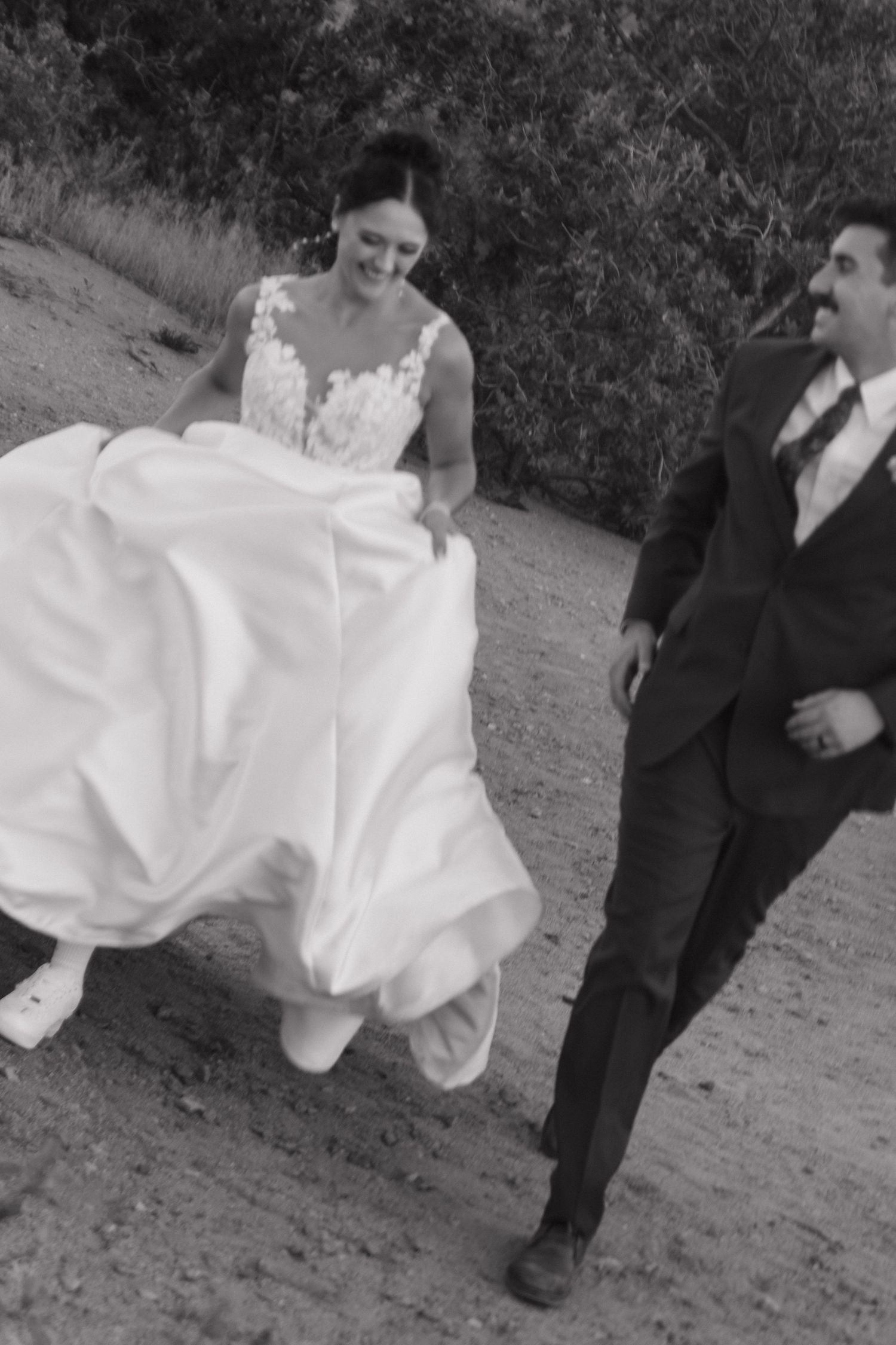 Black and white candid shots of wedding party walking outdoors.