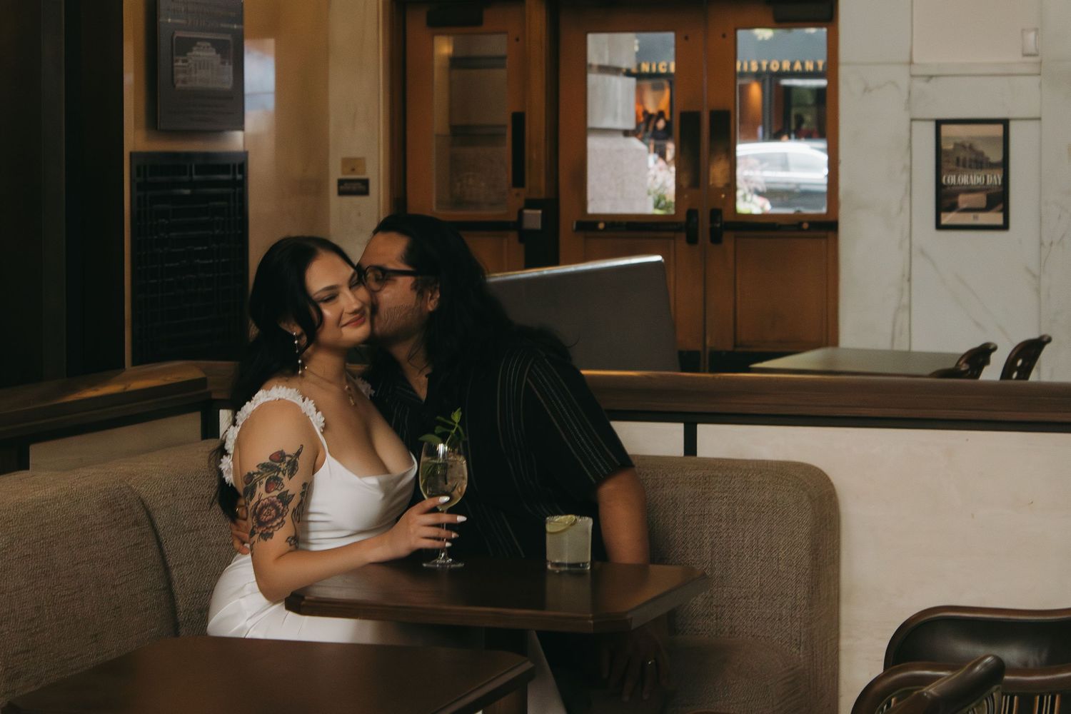 Couple shares intimate moments in rustic restaurant setting with vintage decor.