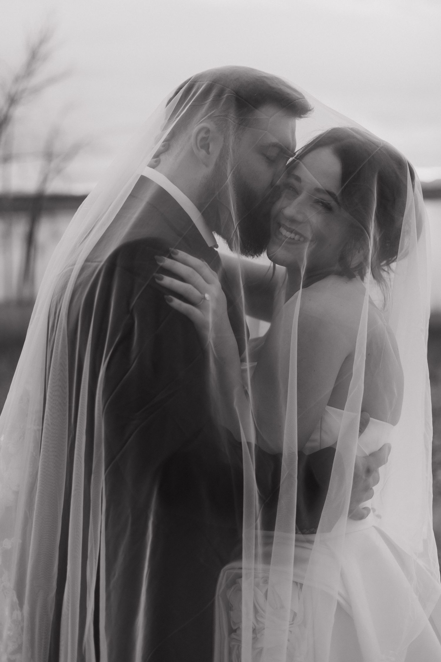 Romantic black and white sequence through wedding veil creating dreamy effect.