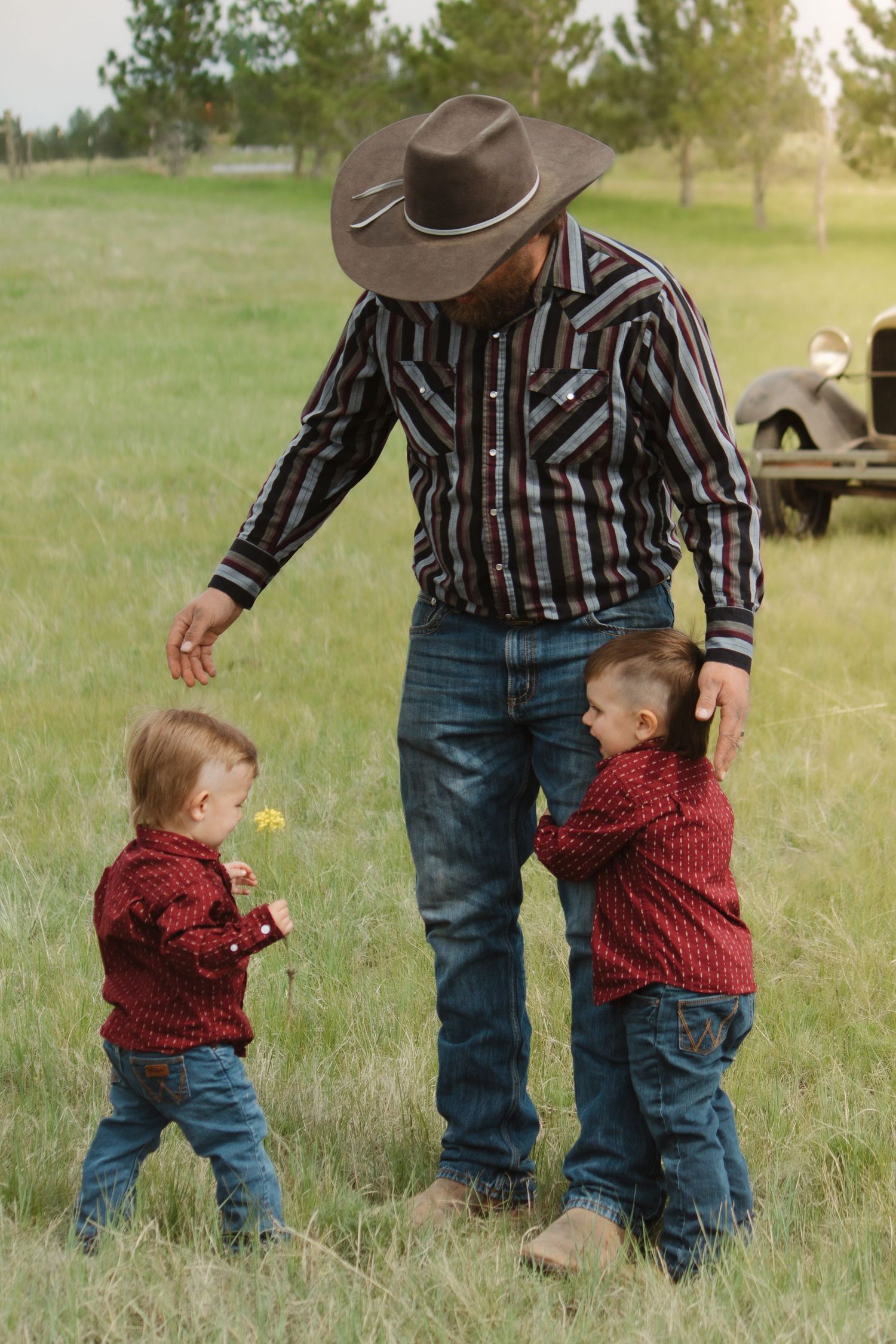 A series of photos showing a playful moment between parent and child in matching outfits in a grassy field.
