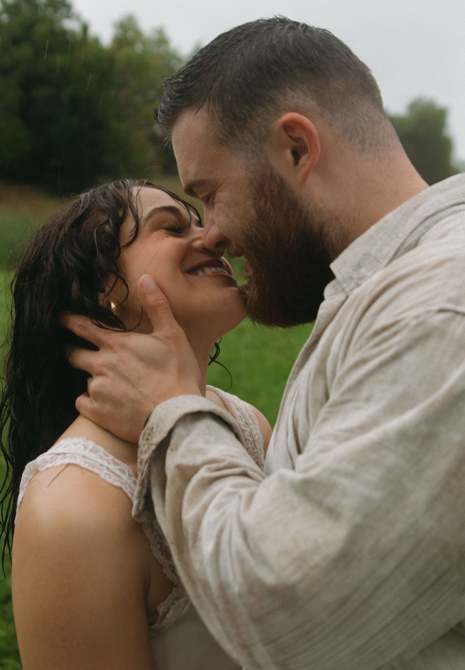 A romantic sequence of intimate moments captured between a couple kissing outdoors in nature.