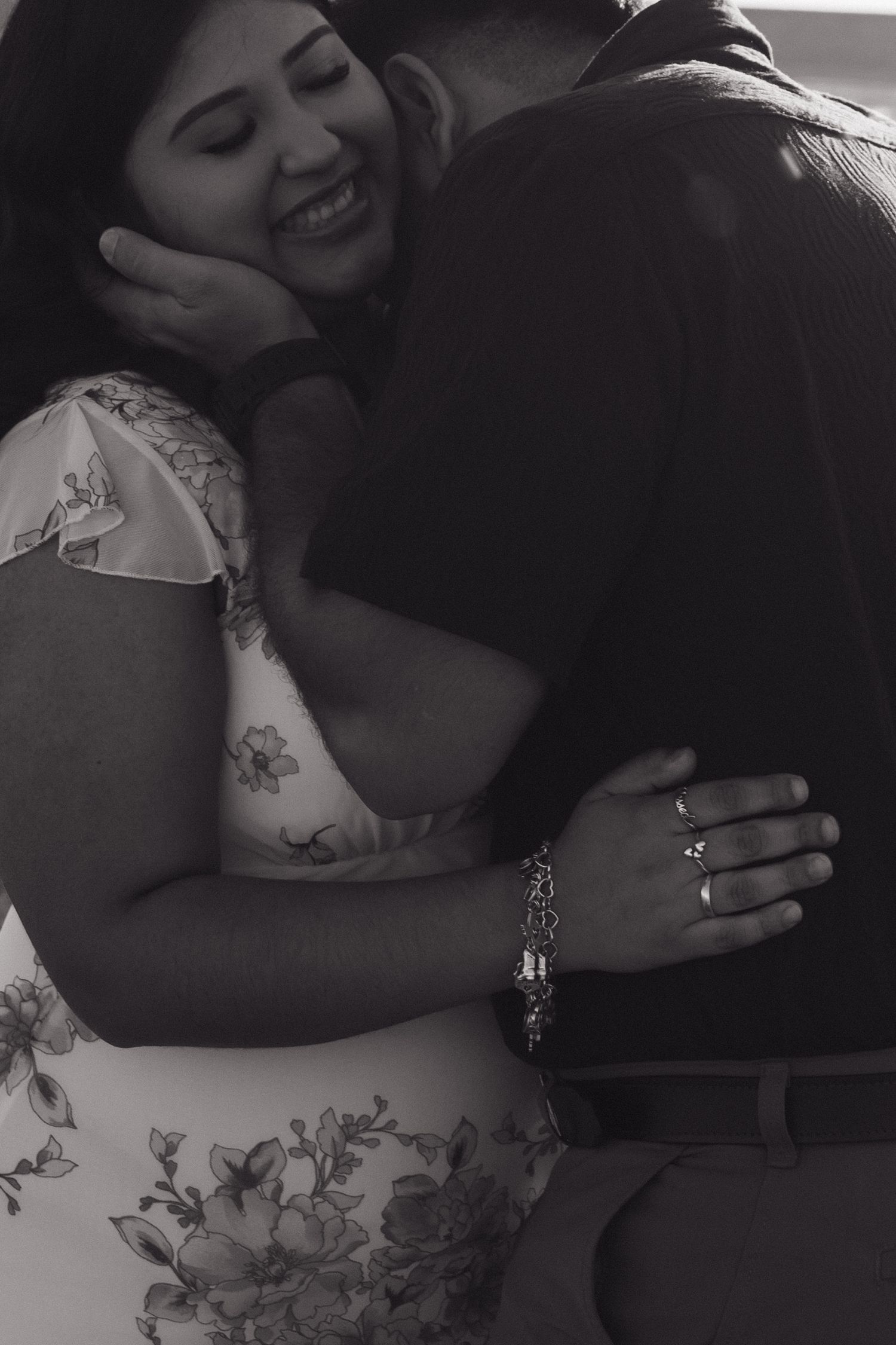 A romantic black and white photo of a couple in an intimate embrace.