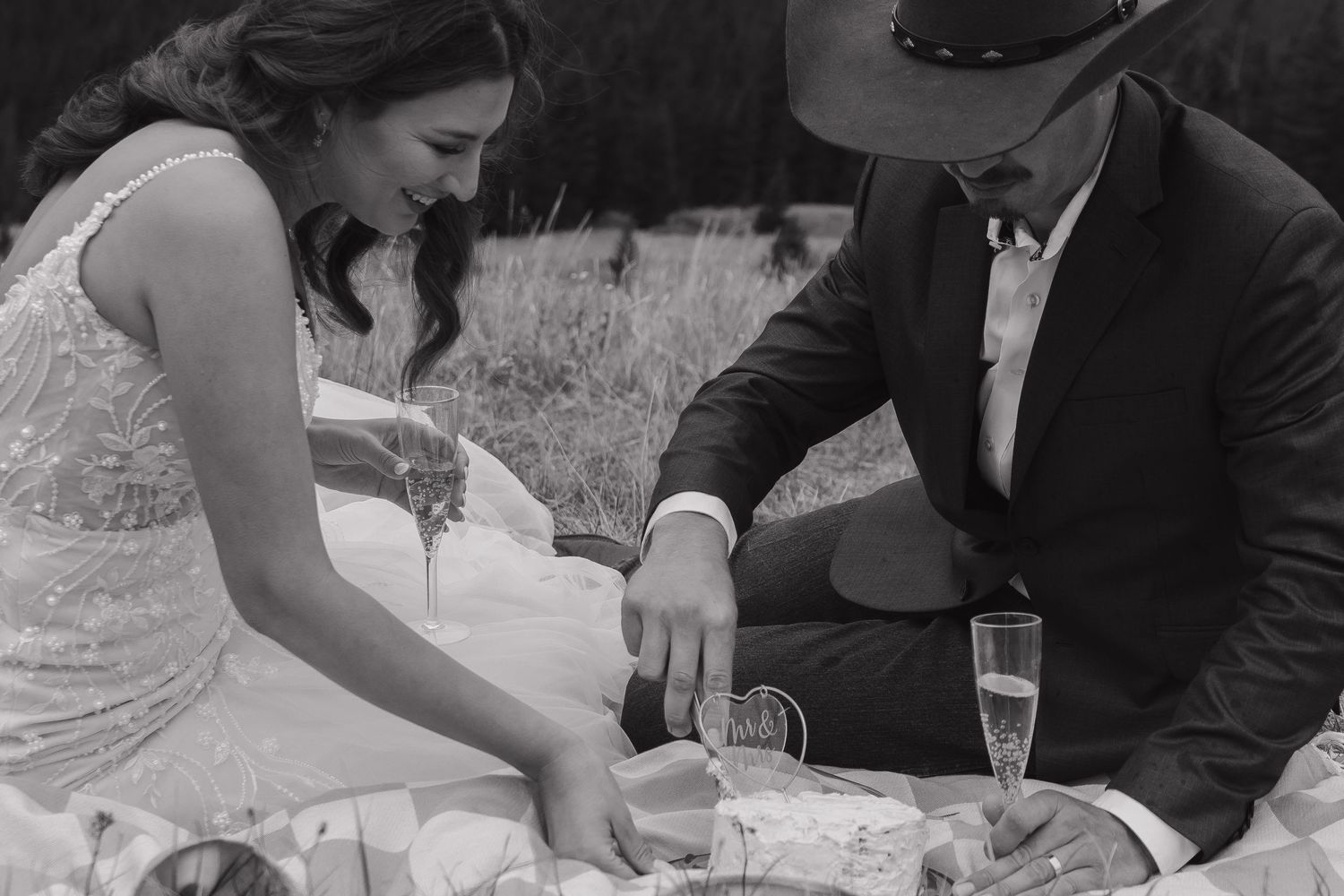 Wedding couple sharing tender moments during their outdoor mountain ceremony.