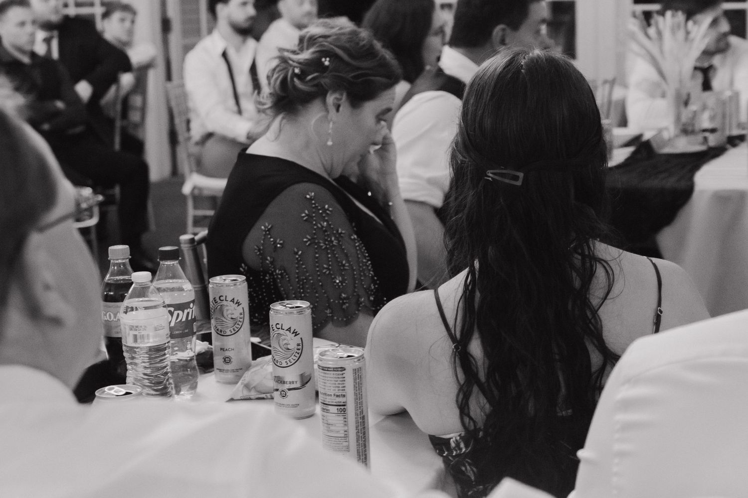 Black and white photo of guests mingling at a social gathering.