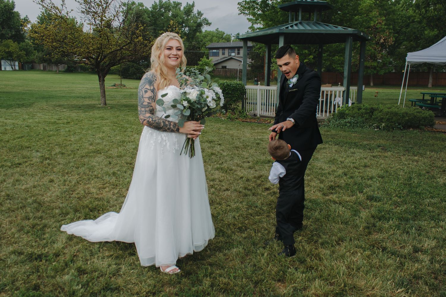 A wedding photo series captured in a park setting with gazebo and natural landscaping.