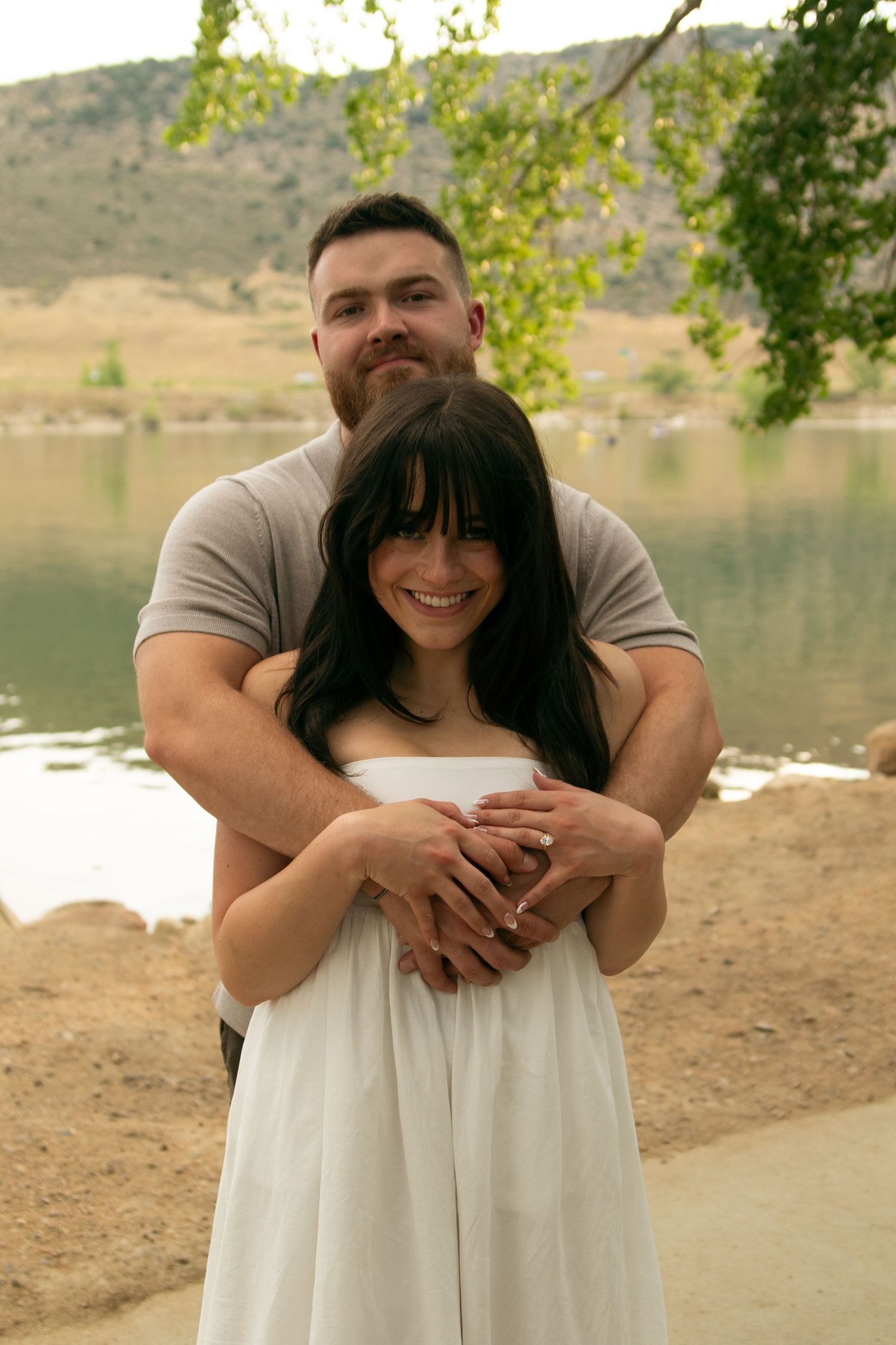 A romantic photo series showing a couple in casual and formal wear by a scenic lakeside.