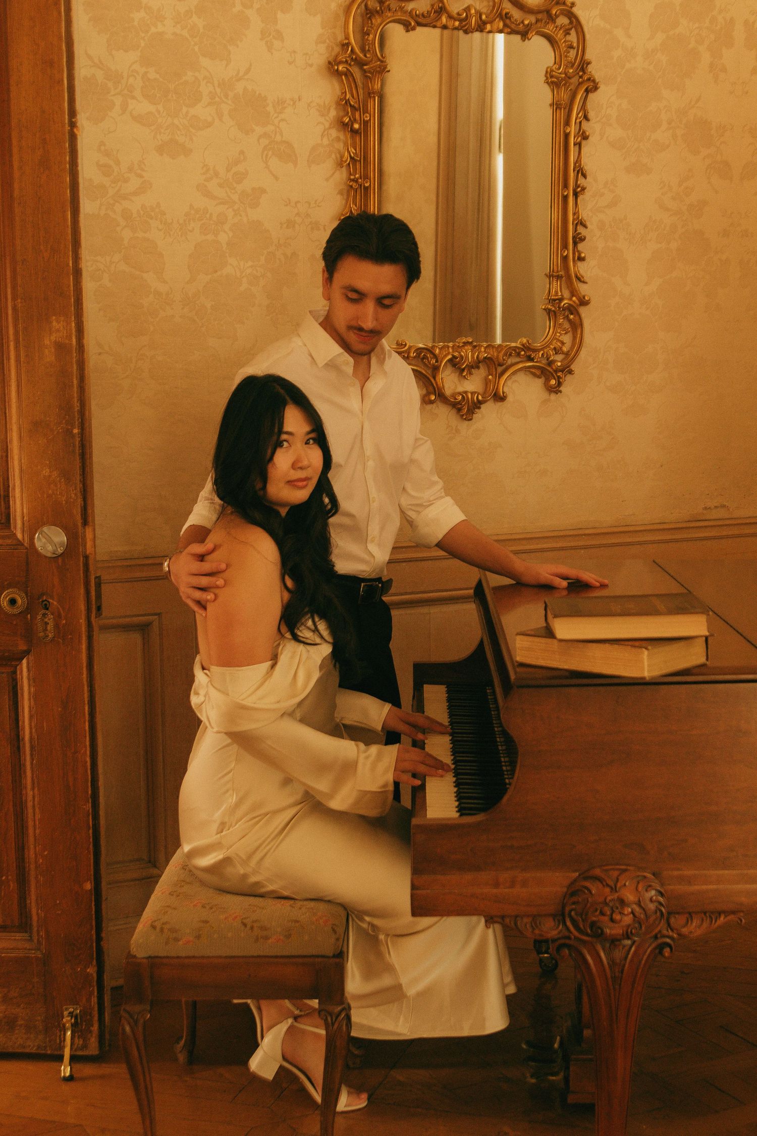 A romantic sequence of dance moves in an elegant room with ornate gold mirrors and wallpaper.