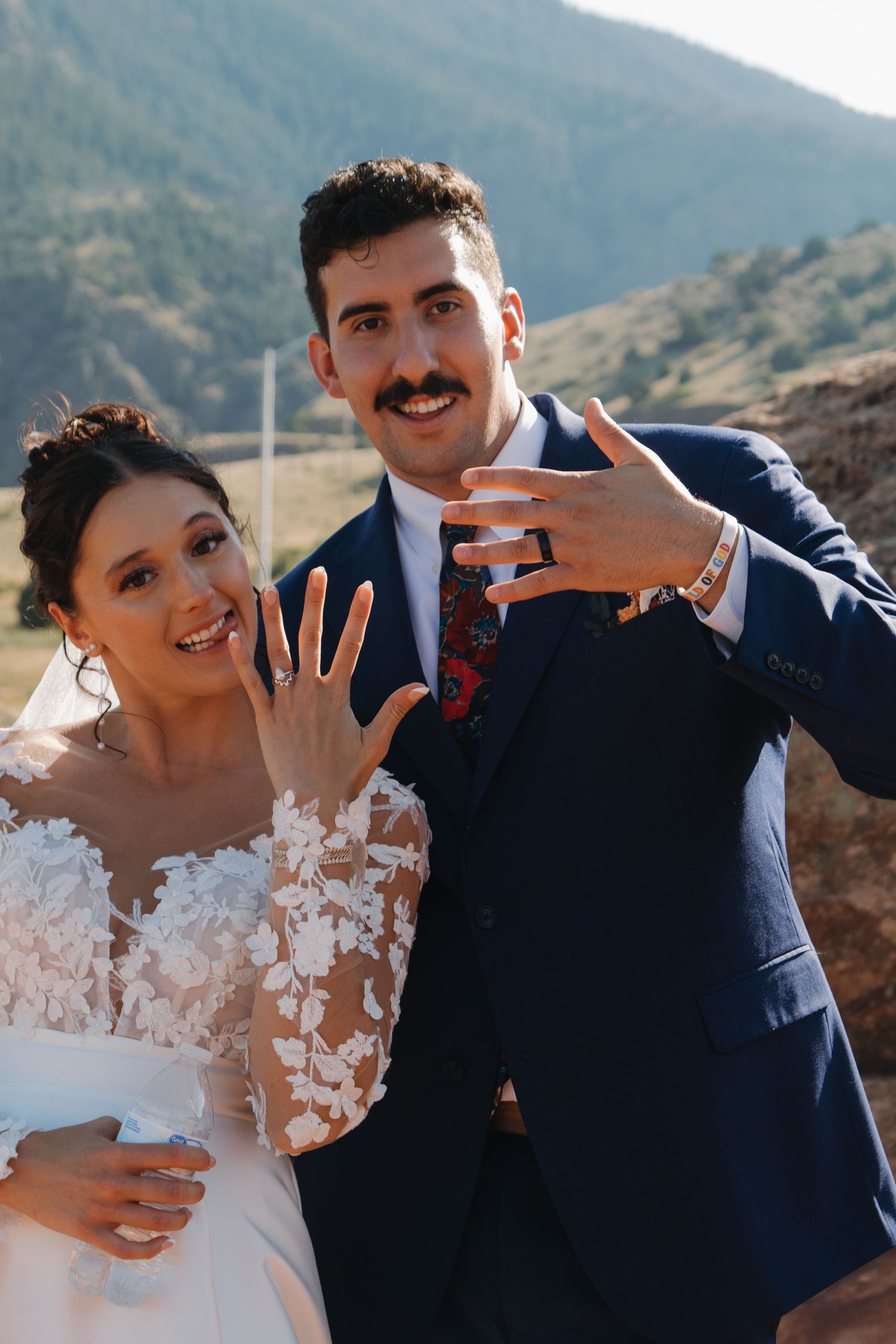 A couple shares intimate moments in a series of wedding photos with mountains in the background.