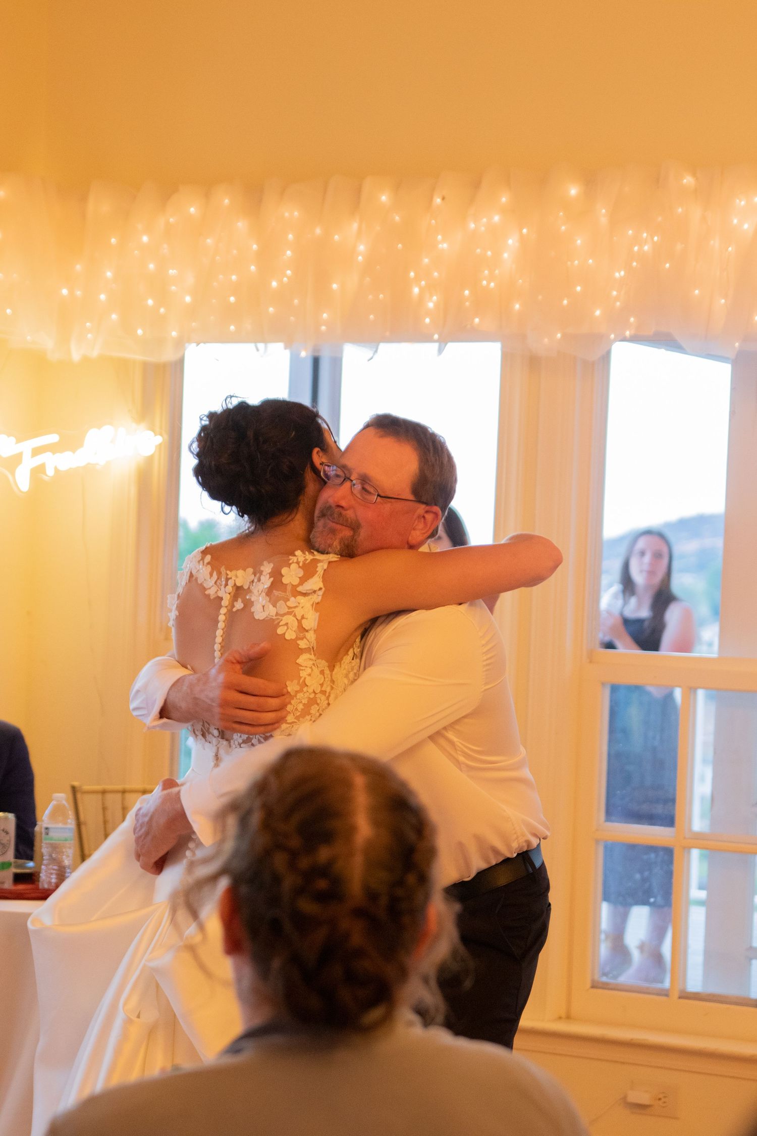 Wedding dance moment under twinkling fairy lights.