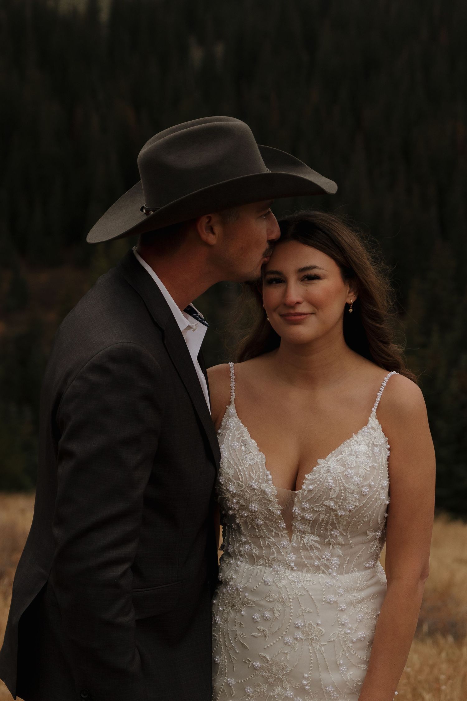 A romantic sunset photo sequence showing a couple in western wedding attire against a rustic backdrop.
