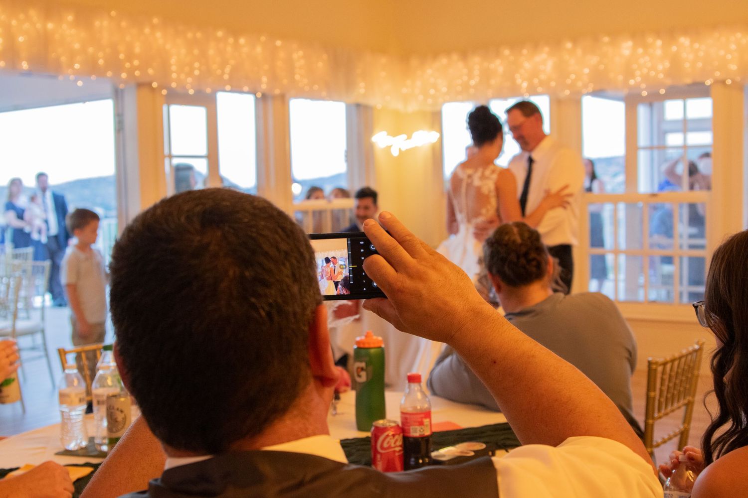 Wedding reception venue decorated with string lights creating a warm, romantic atmosphere.