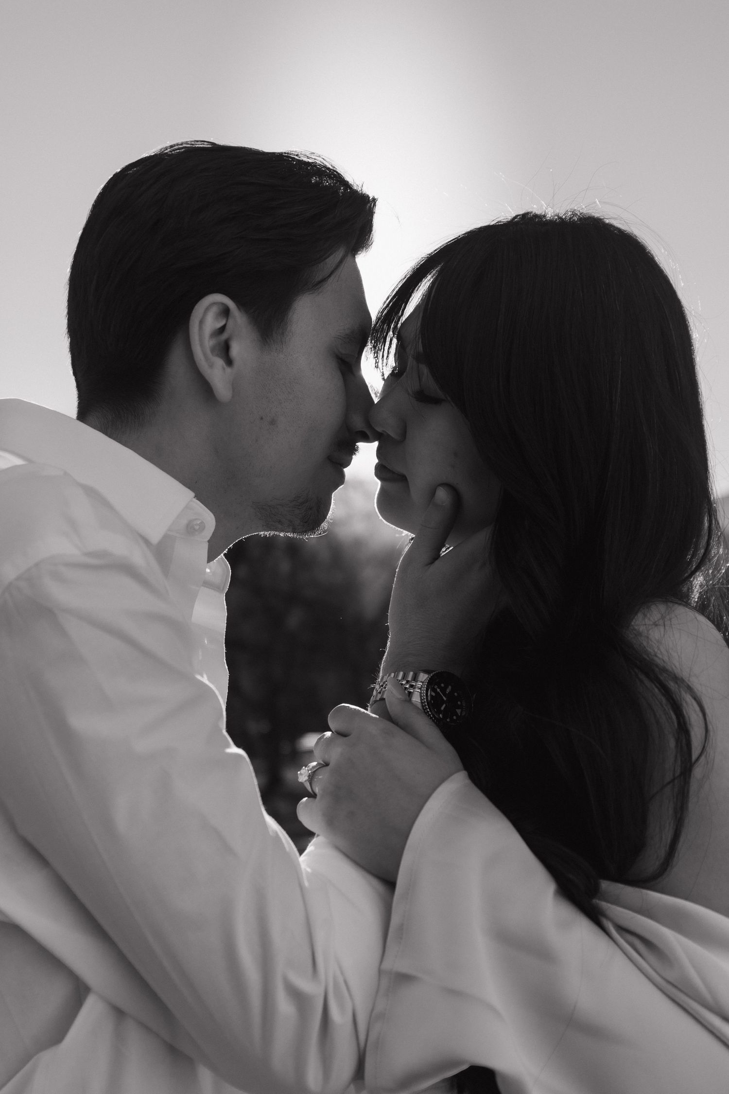Intimate black and white portrait of a couple sharing a tender moment.