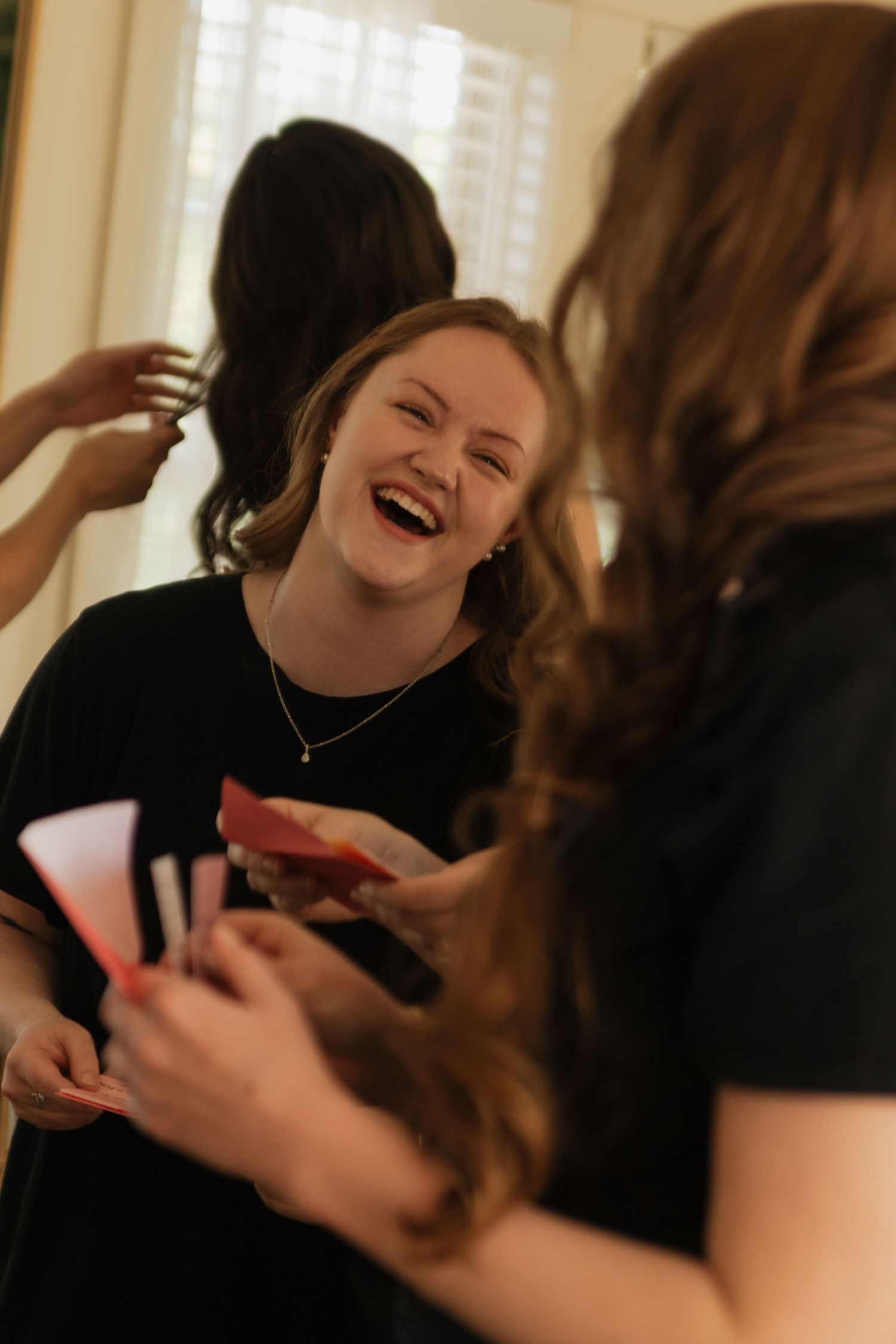 A joyful moment captured during wedding preparations indoors.
