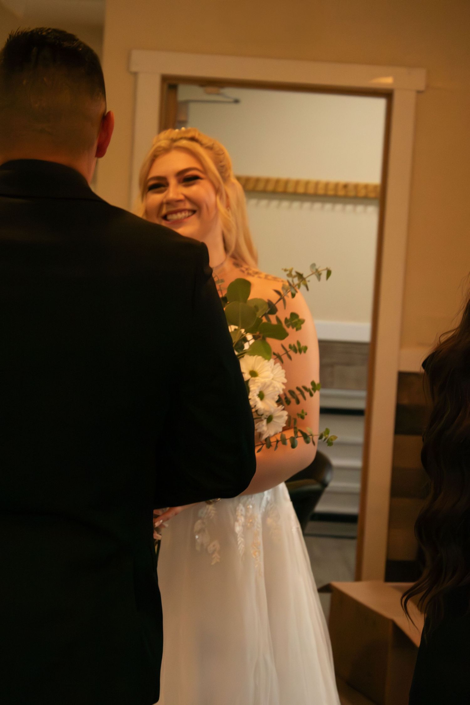 An intimate indoor wedding moment showing a couple sharing smiles and joy.