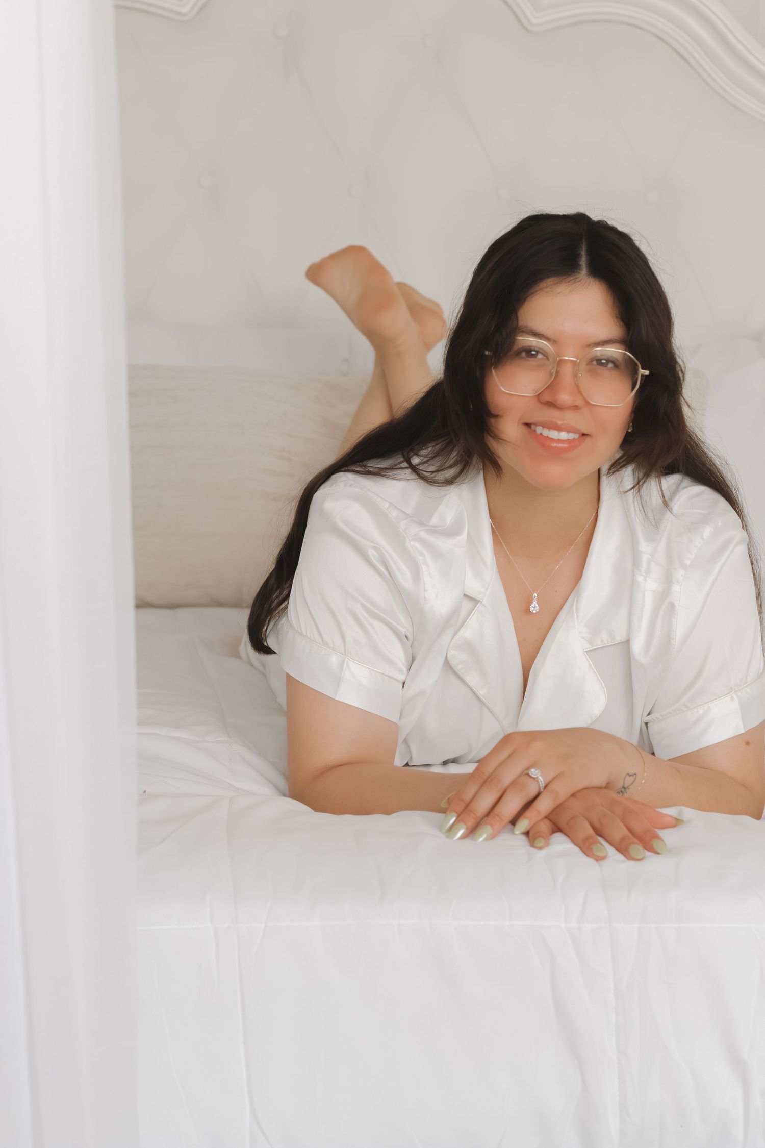A relaxed boudoir photo featuring white linens and casual loungewear.
