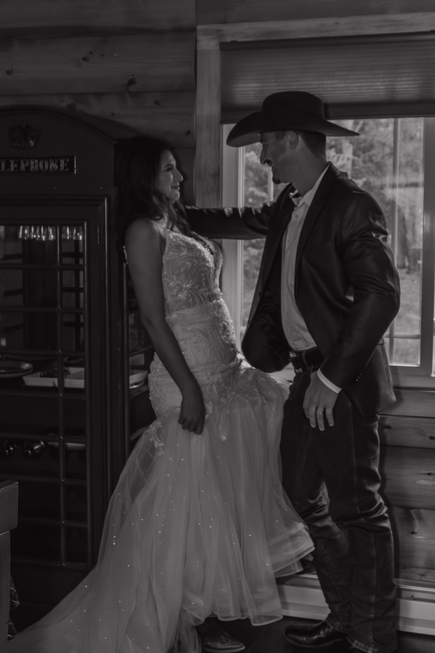 A western-themed wedding scene with a vintage telephone booth in the background.