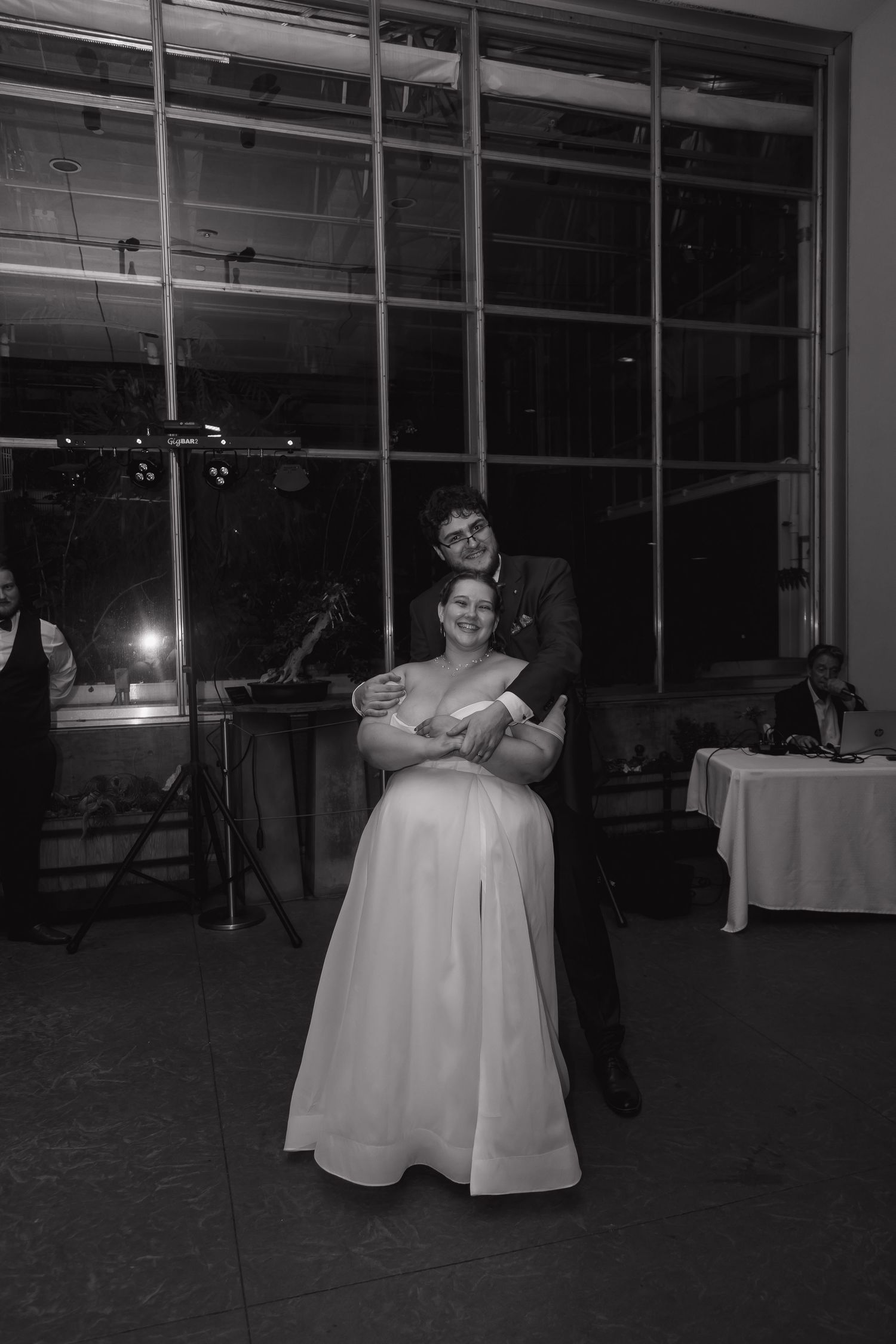 Bride and groom share their first dance in black and white wedding reception photo.
