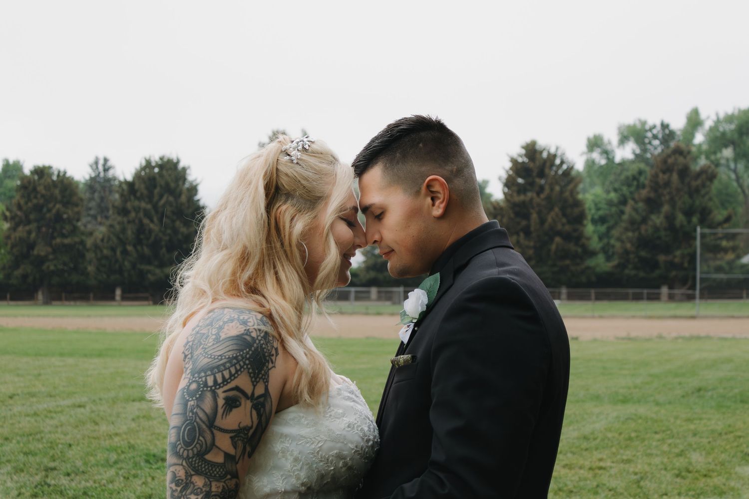 Romantic outdoor wedding photography session showing intimate moments between the couple.