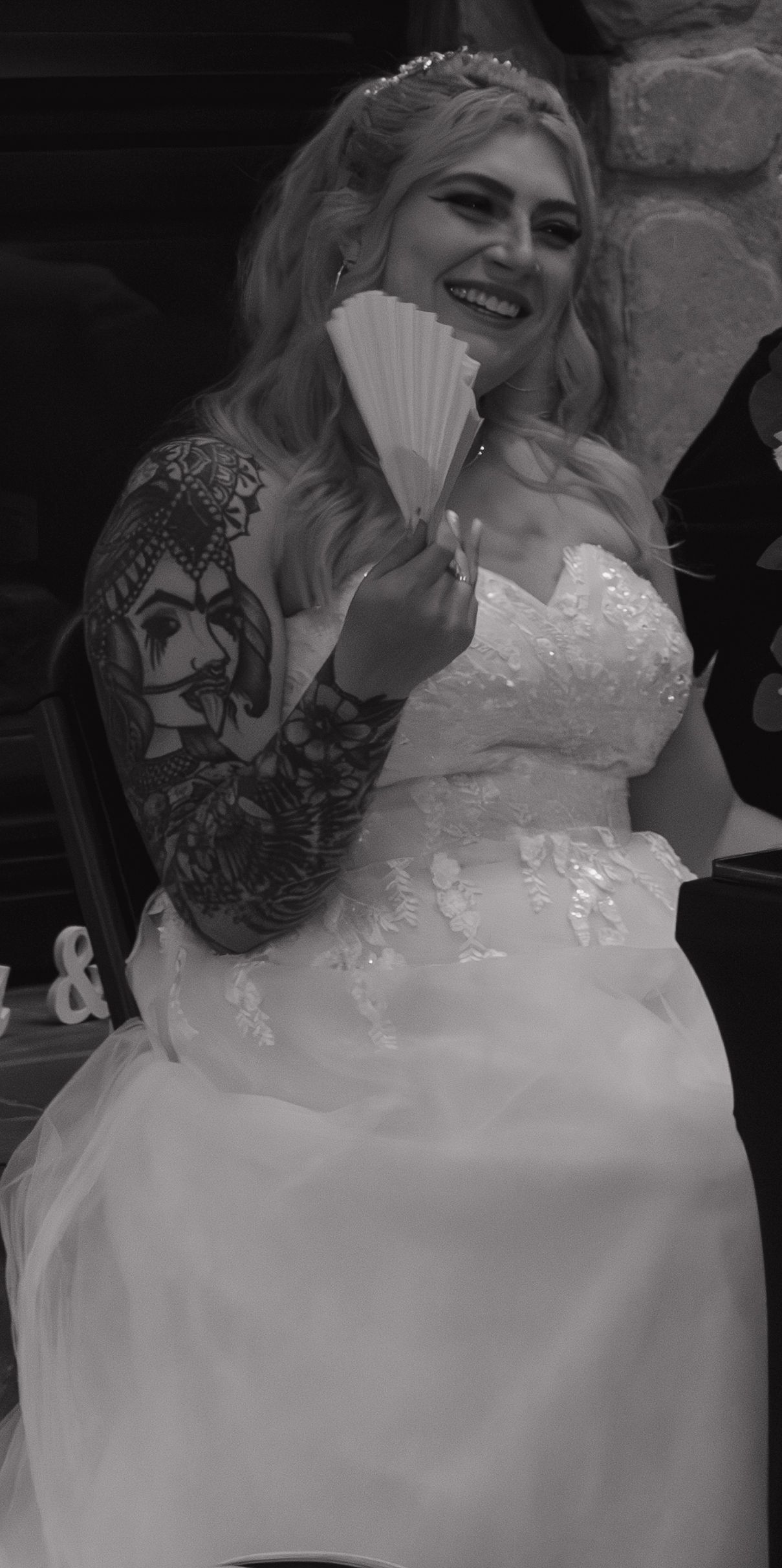 Close-up of an elegant white wedding dress with intricate lace and sparkle details.
