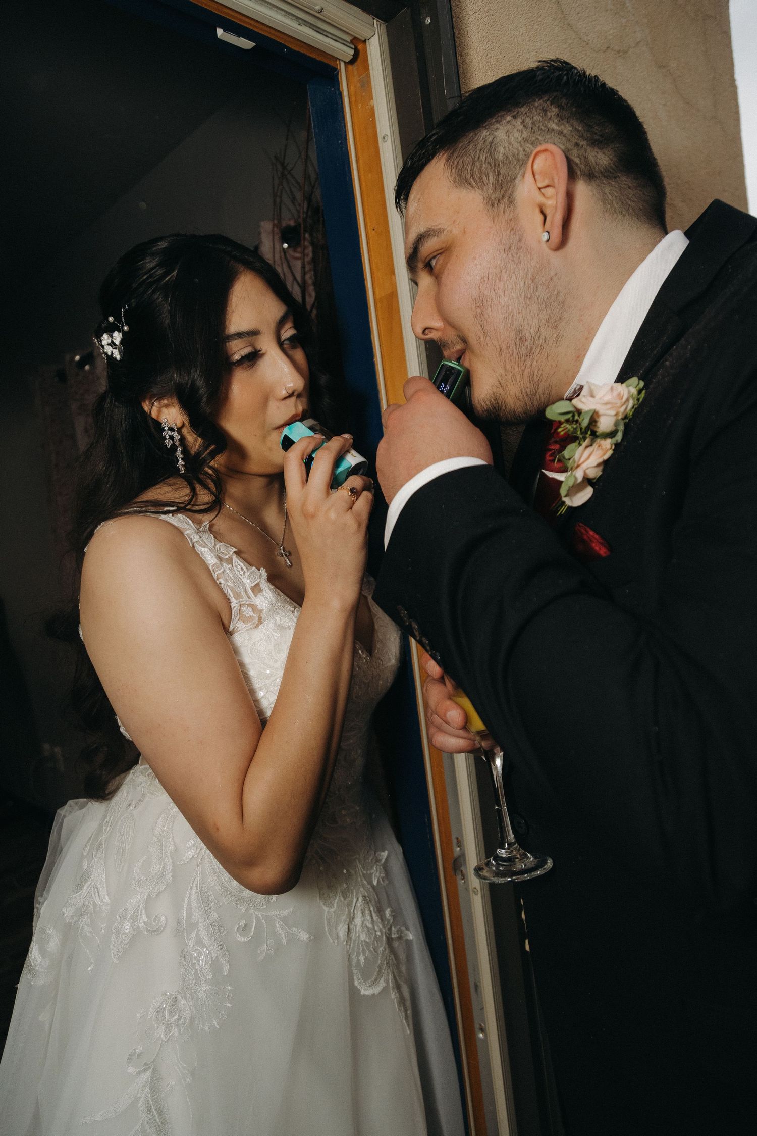 Bride and groom share a sweet macaron together during their wedding reception celebration.