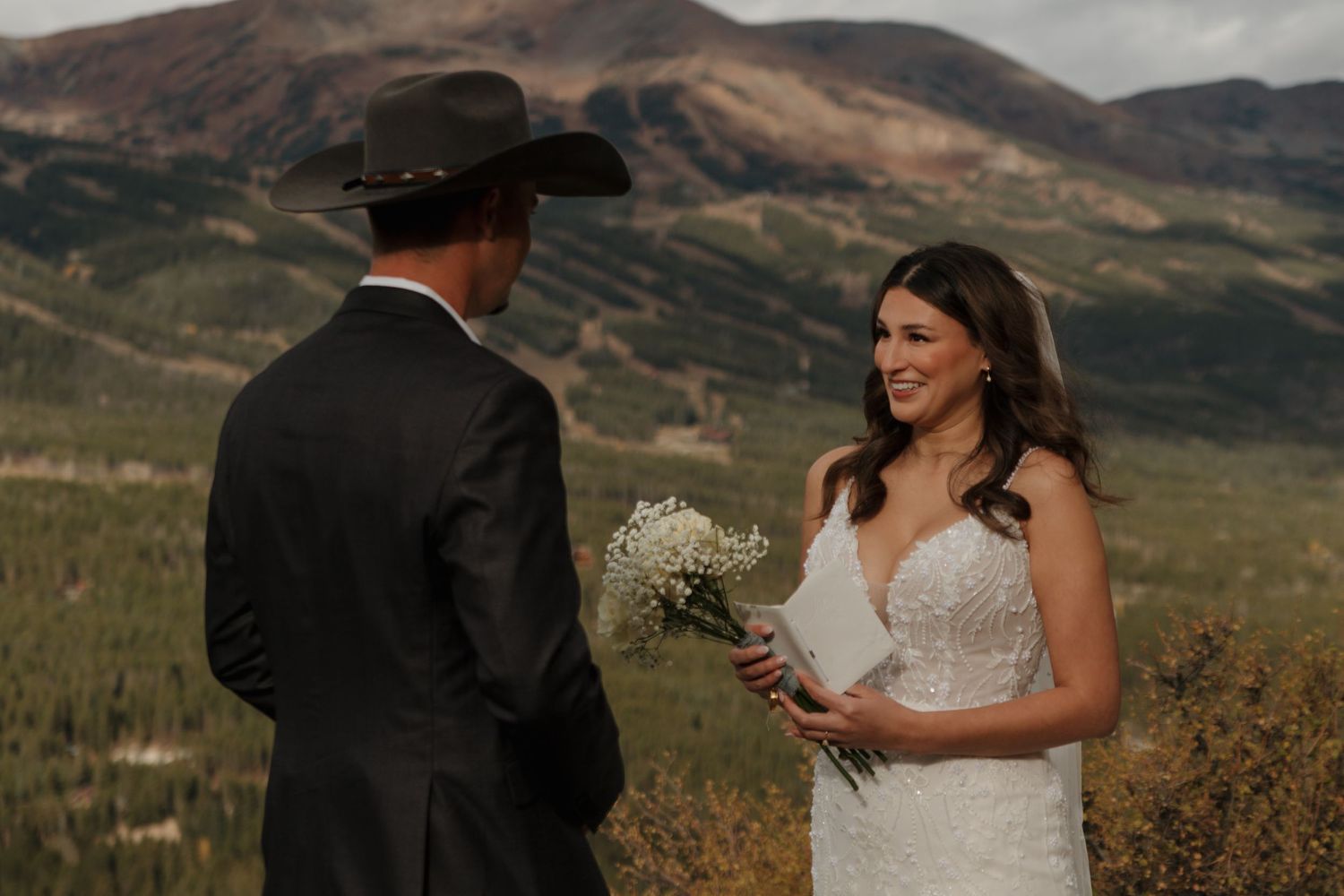 A scenic mountain wedding backdrop with rolling hills and autumn colors in the distance.