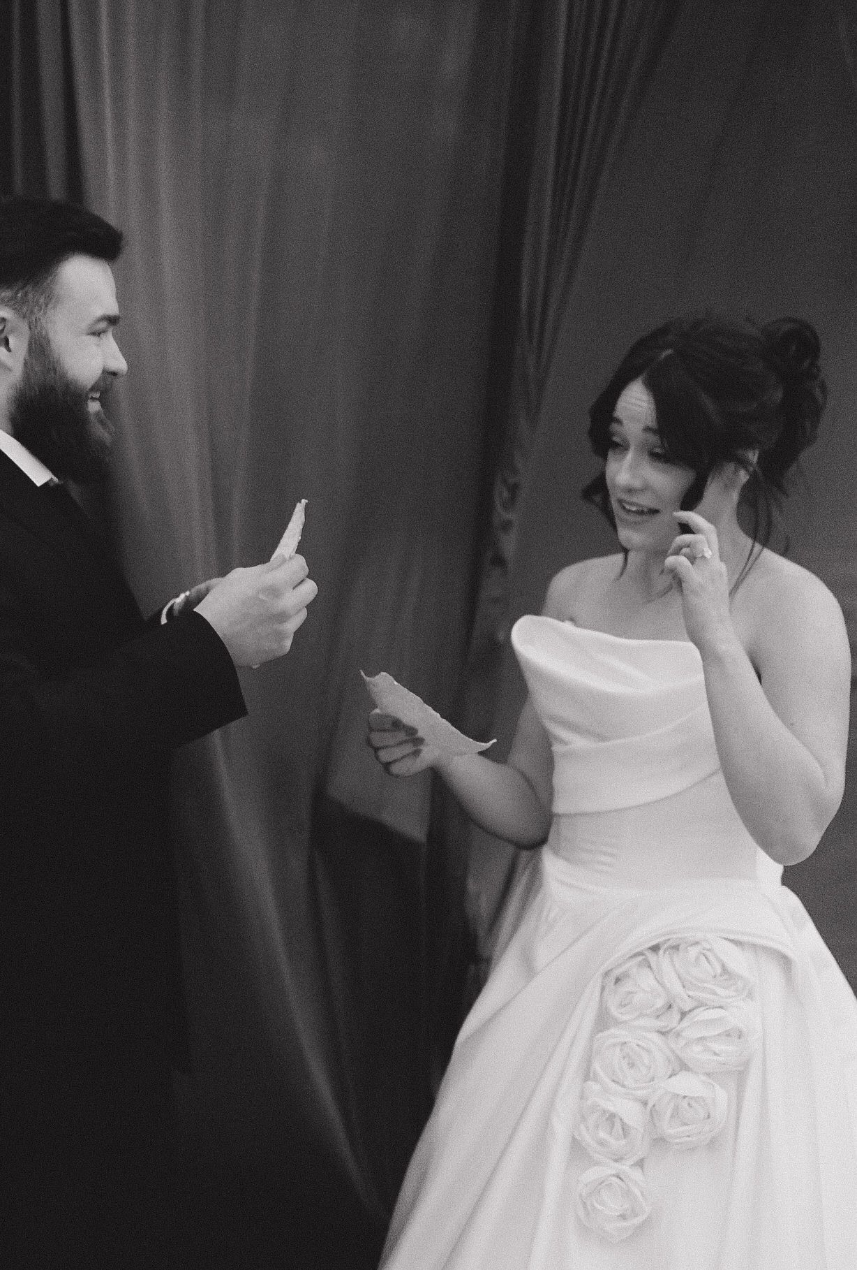 A bride in a classic white wedding gown with elegant floral details.