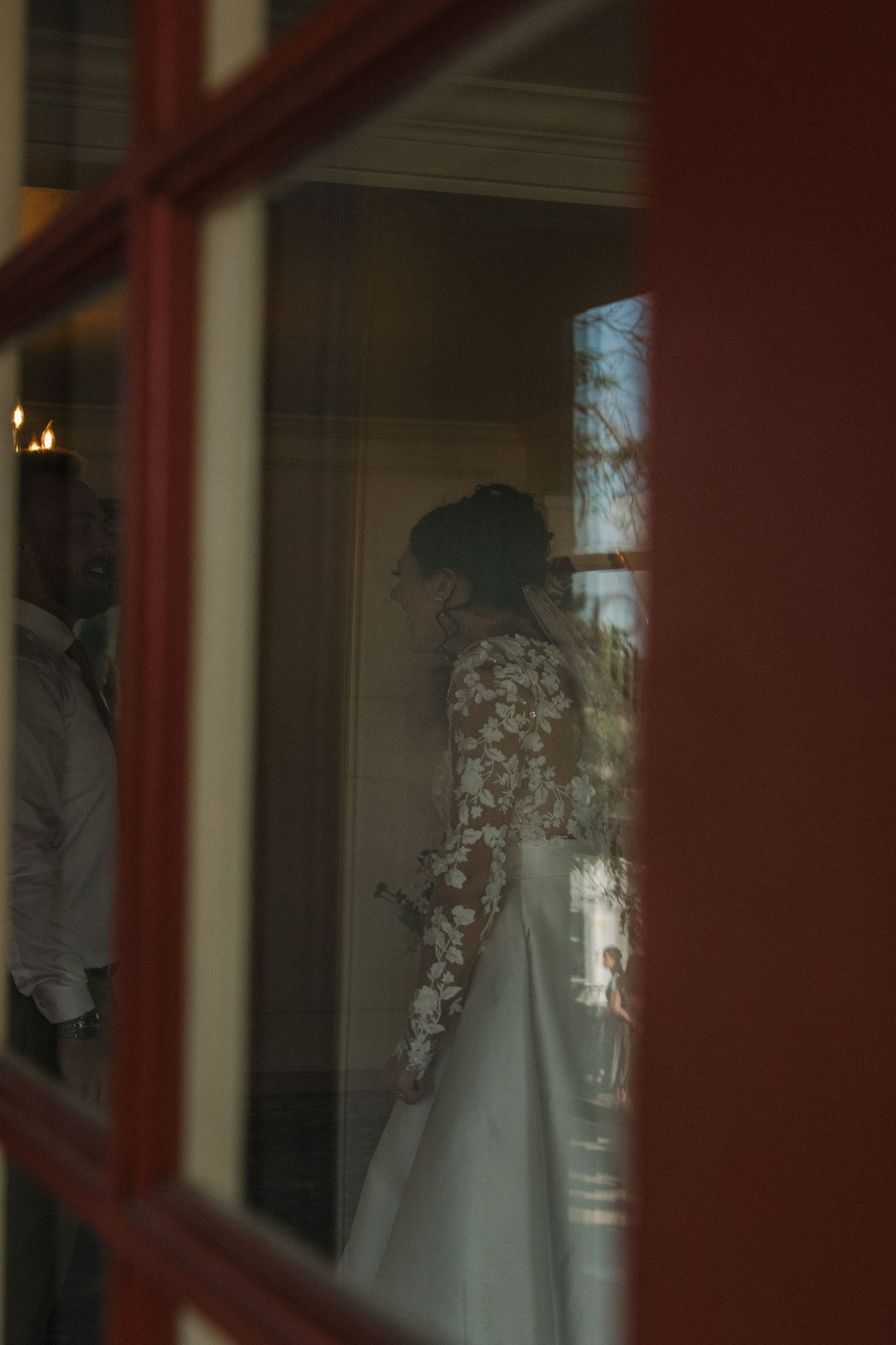A wedding dress displayed in an elegant window setting.