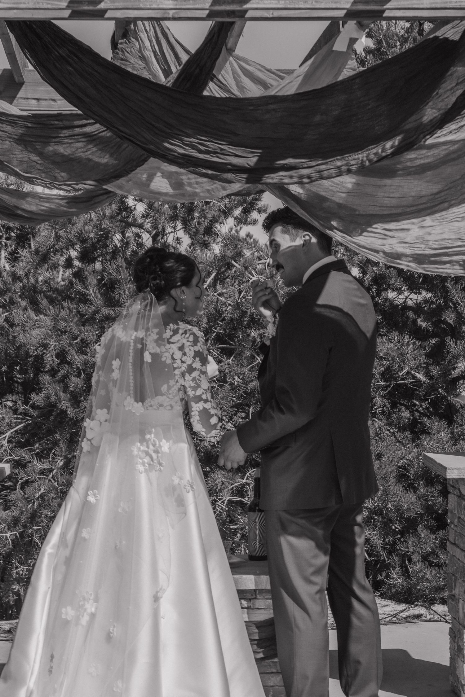 White wedding dress with flowing train captured in black and white sequence.